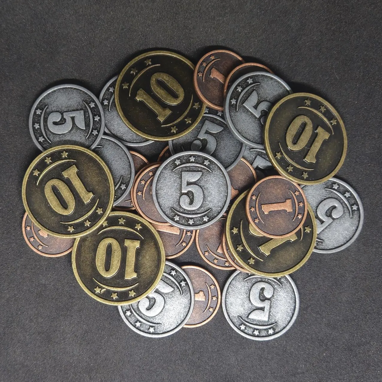 Set of bronze, silver and gold western metal coins of value 1, 5 and 10 for board games