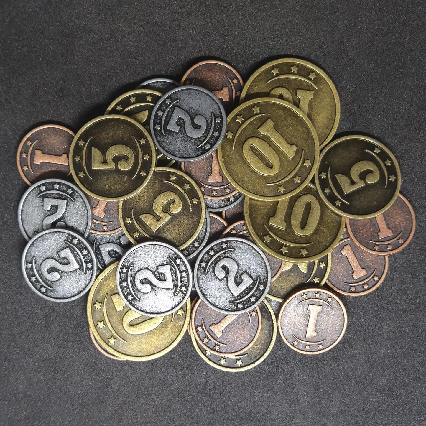 Set of bronze, silver and gold western metal coins of value 1, 2, 5 and 10 for board games