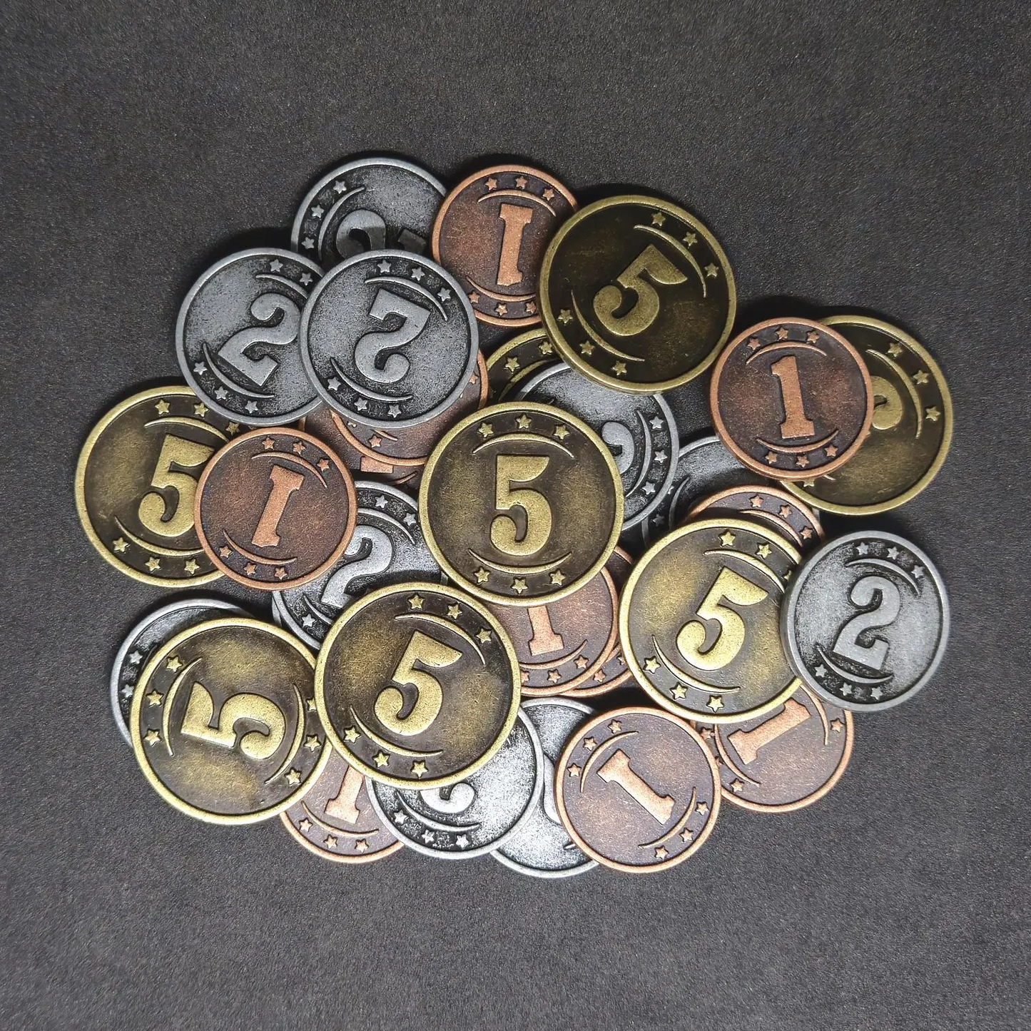Set of bronze, silver and gold western metal coins of value 1, 2, and 5 for board games