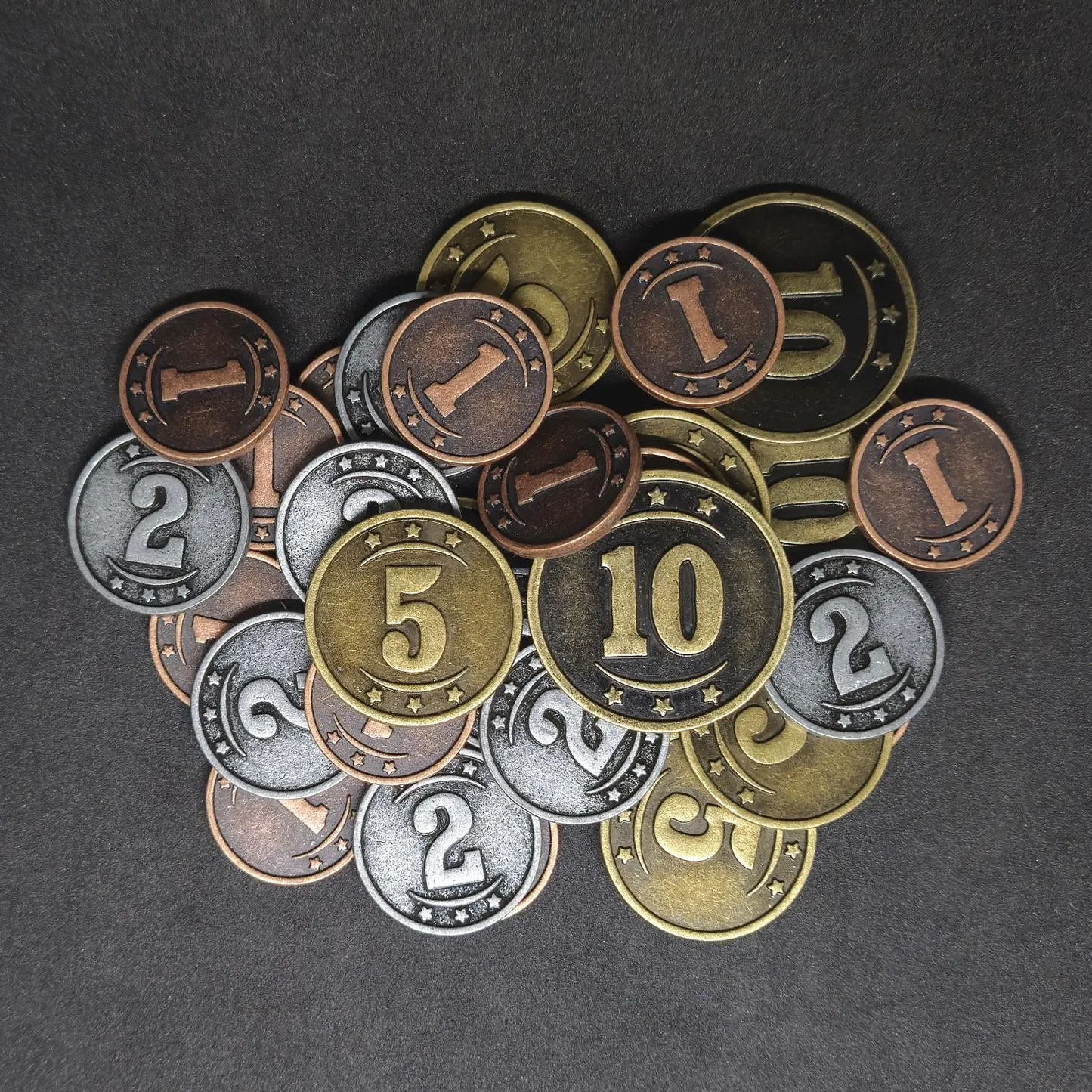 Set of bronze, silver and gold western metal coins of value 1, 2, 5 and 10 for board games