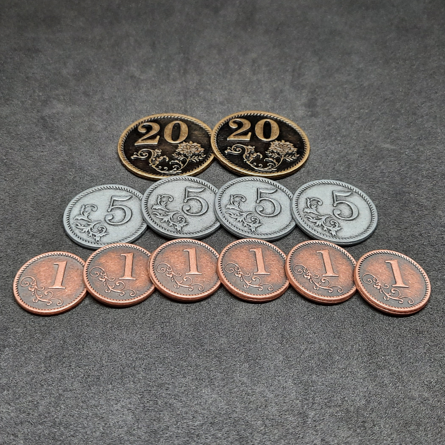 Set of bronze, silver and gold metal coins of value 1, 5 and 20 for board games