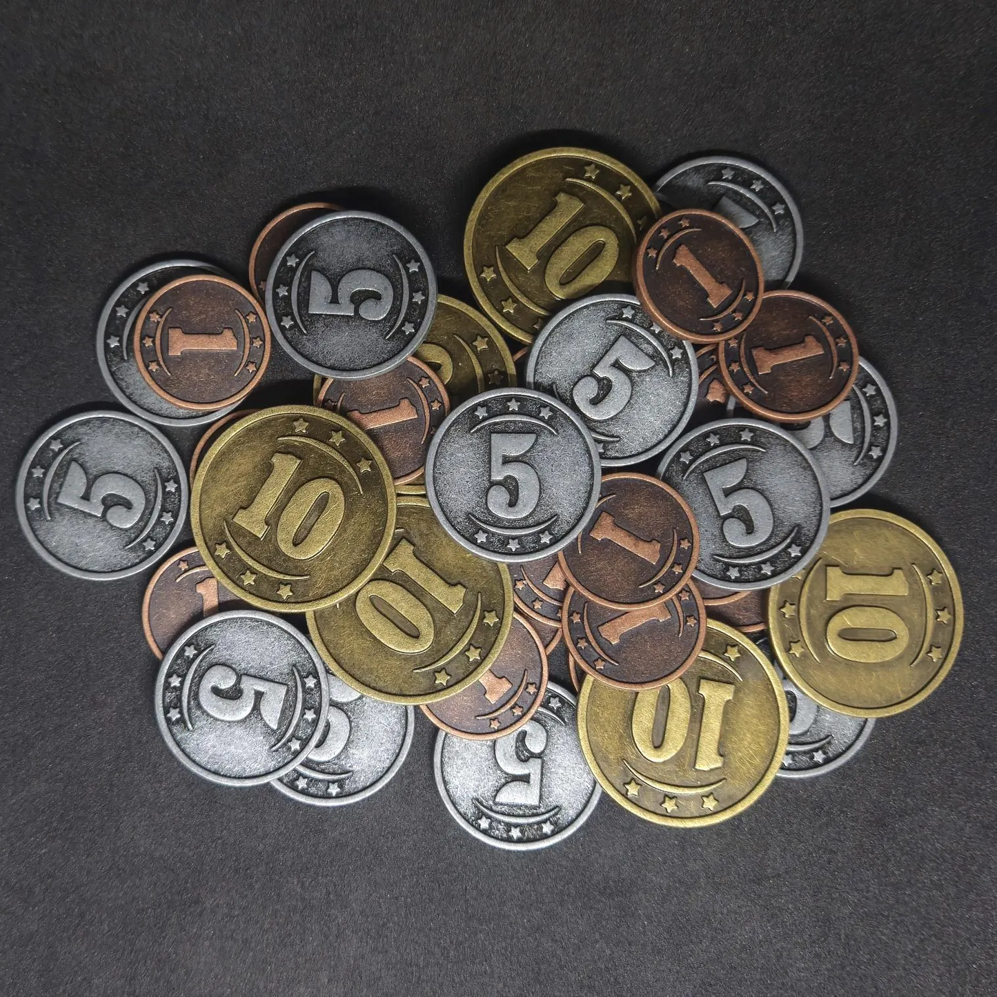 Set of bronze, silver and gold western metal coins of value 1, 5 and 10 for board games