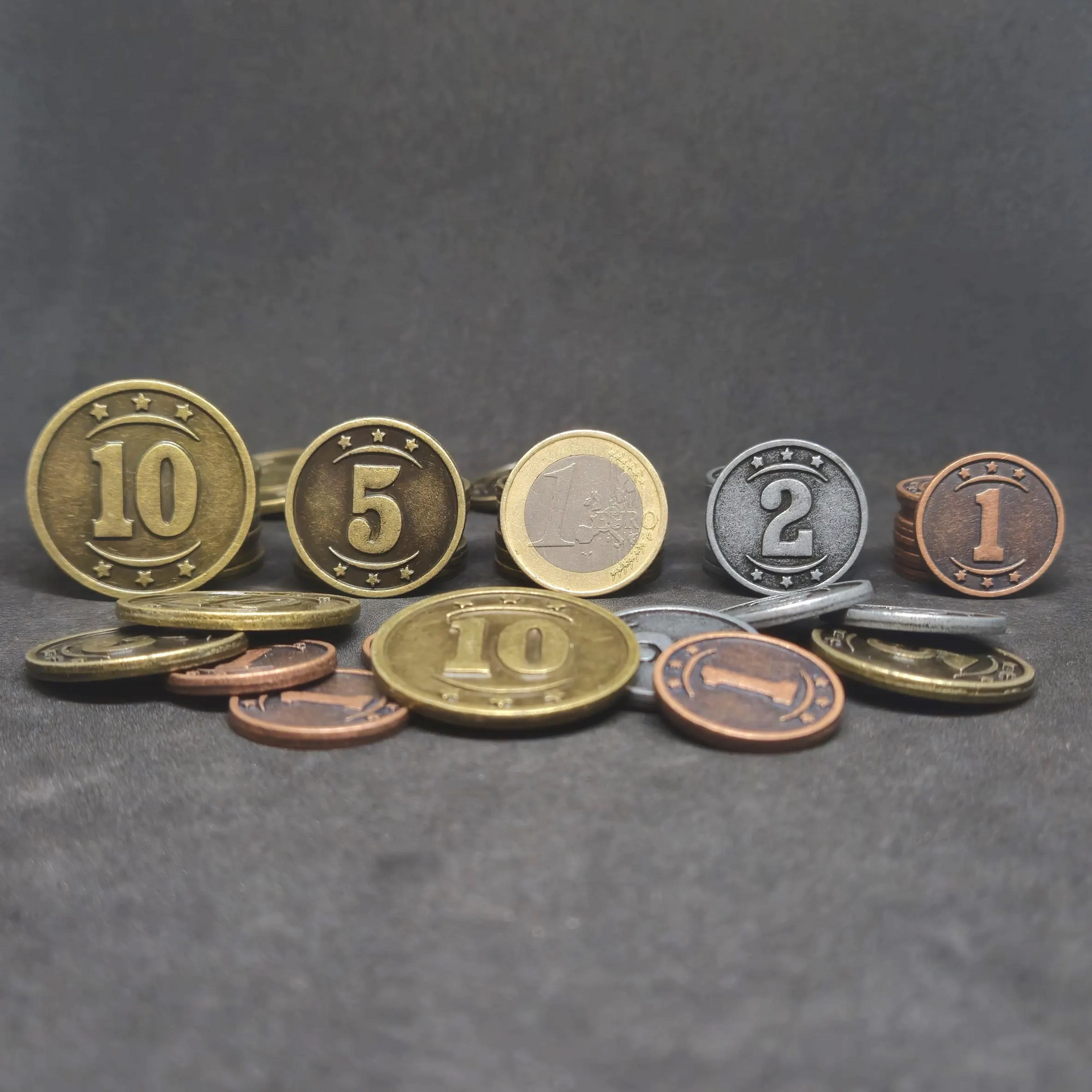 Set of bronze, silver and gold western metal coins of value 1, 2, 5 and 10 for board games