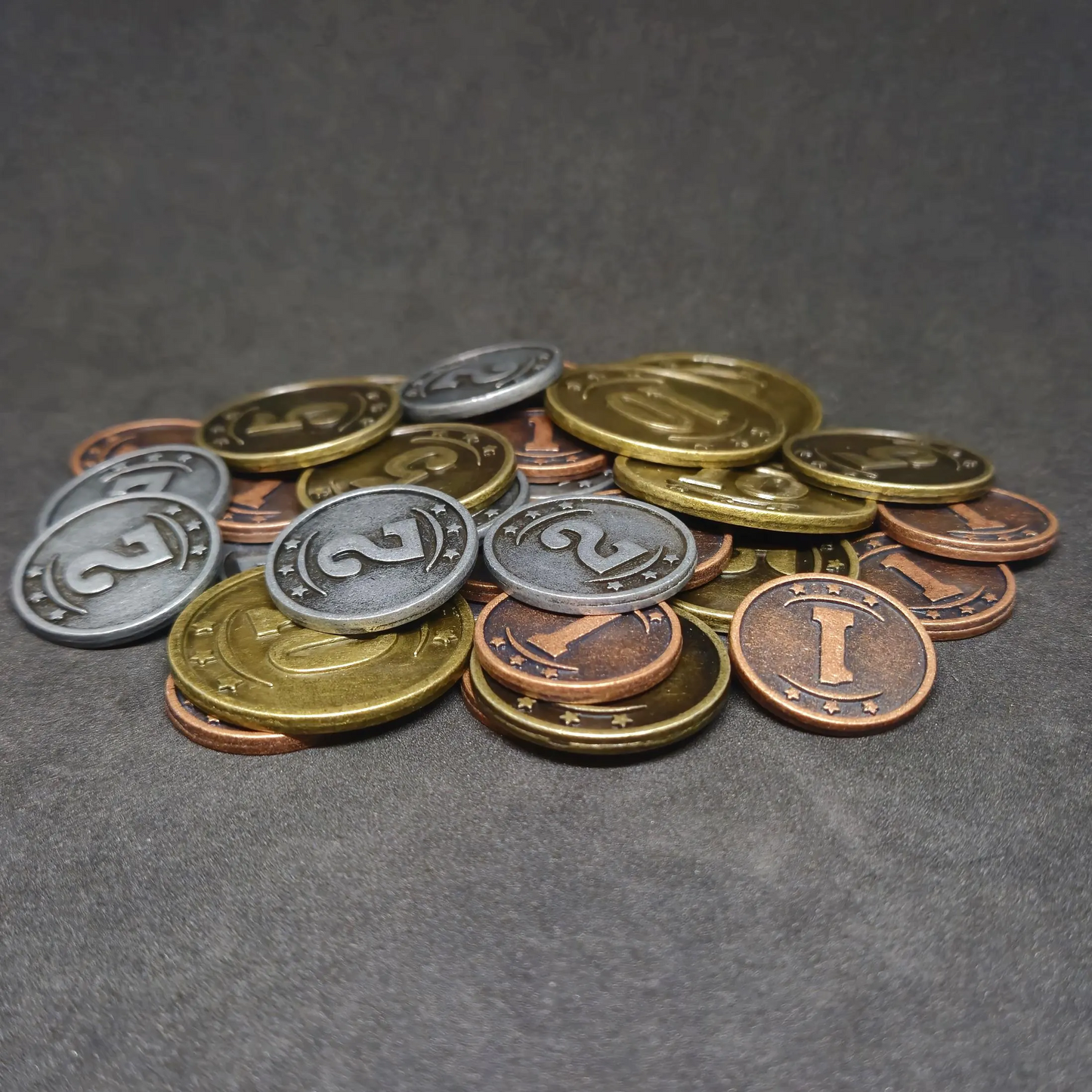 Set of bronze, silver and gold western metal coins of value 1, 2, 5 and 10 for board games