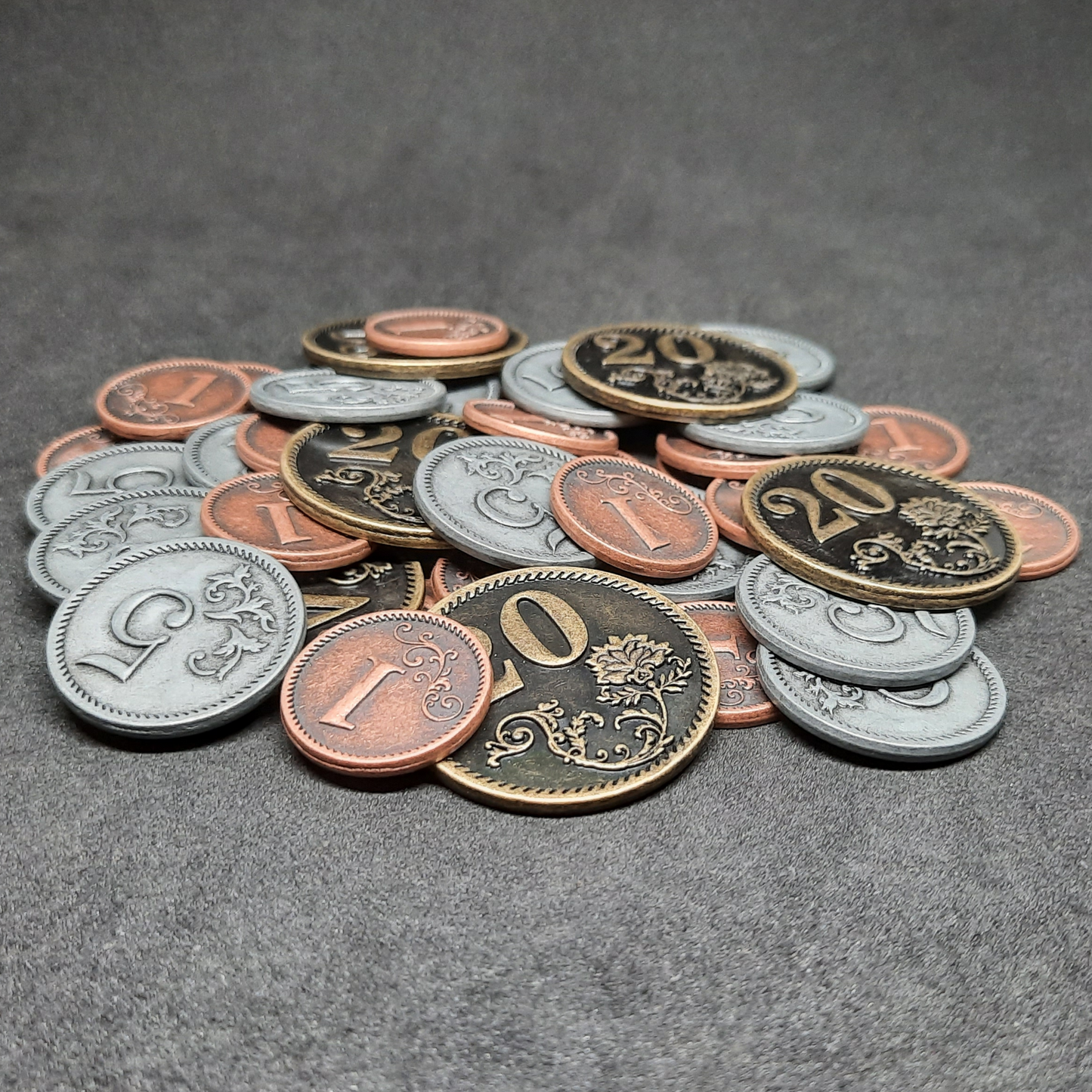 Set of bronze, silver and gold metal coins of value 1, 5 and 20 for board games