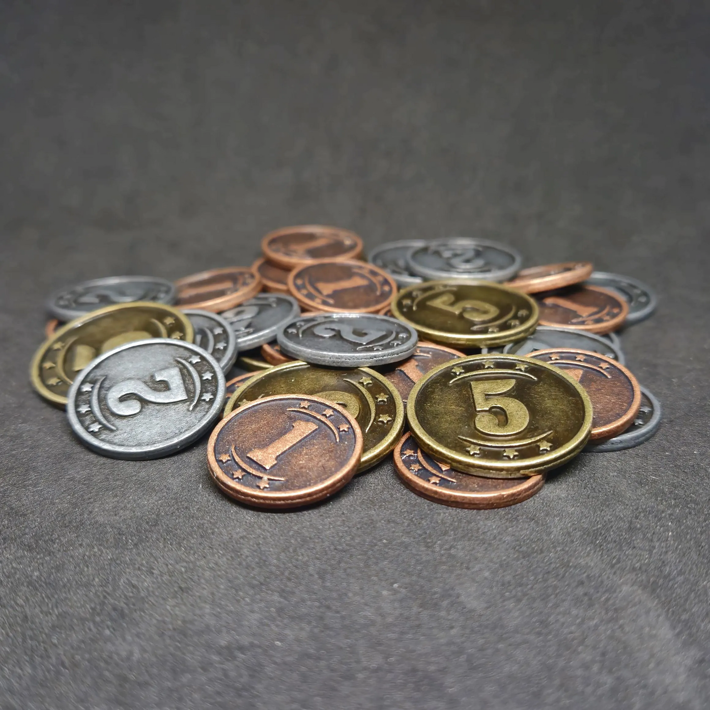 Set of bronze, silver and gold western metal coins of value 1, 2, and 5 for board games