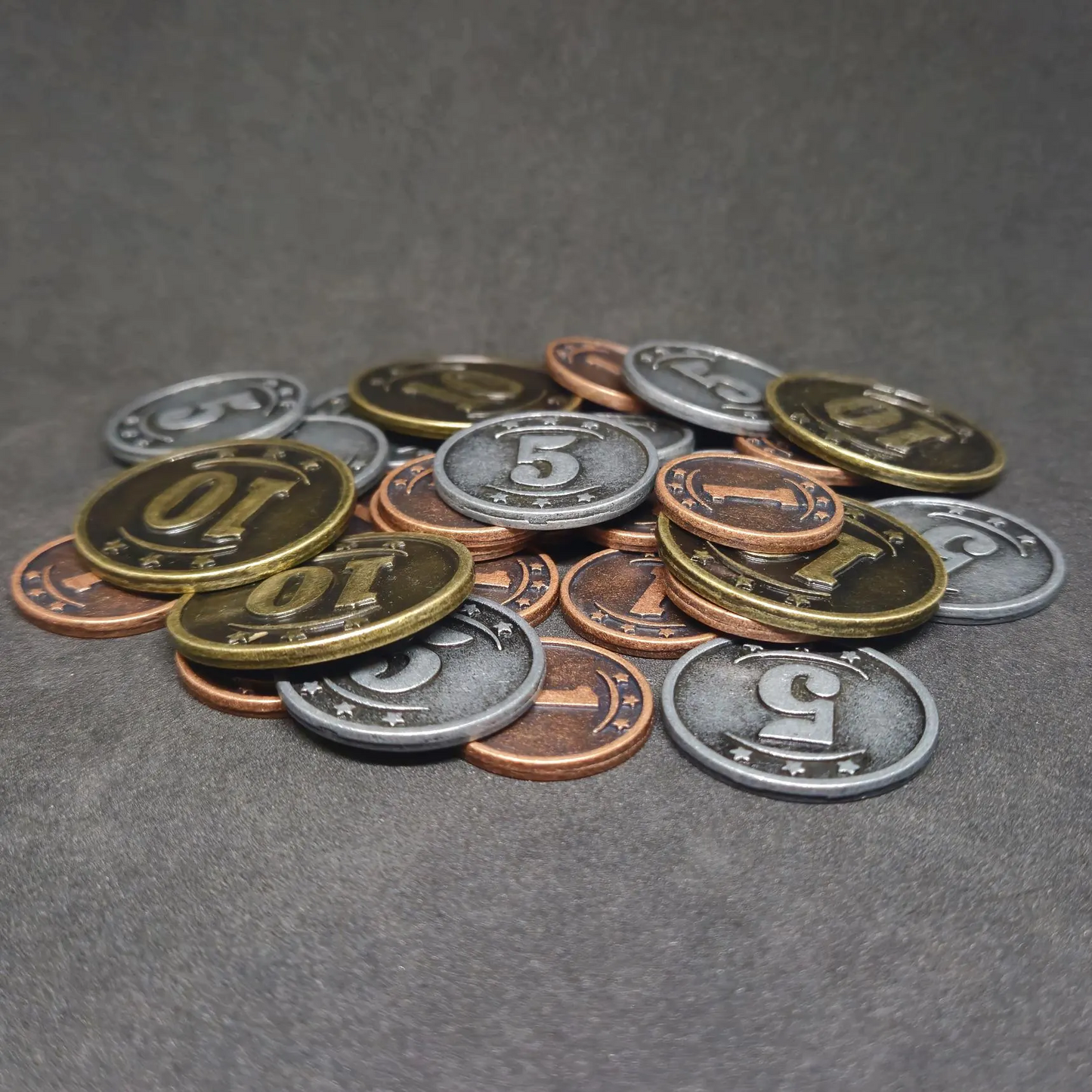 Set of bronze, silver and gold western metal coins of value 1, 5 and 10 for board games