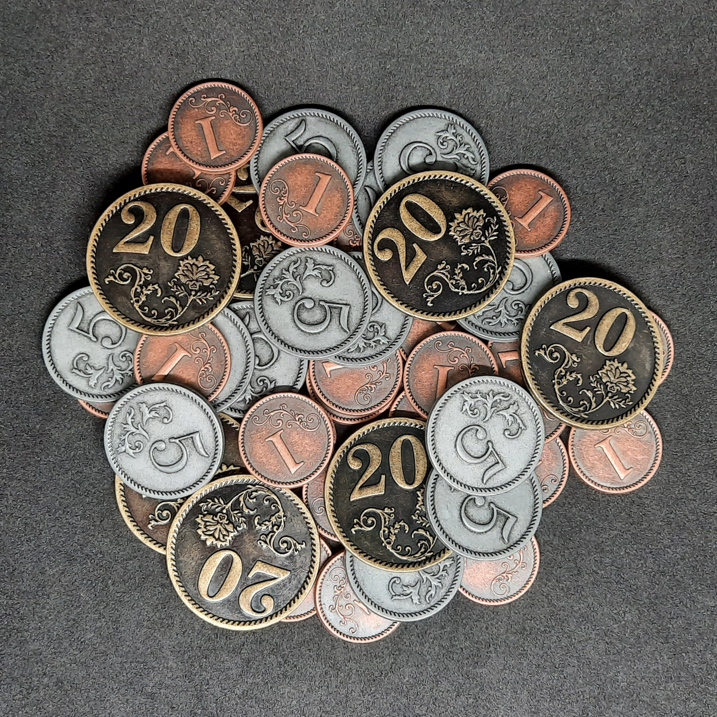 Set of bronze, silver and gold metal coins of value 1, 5 and 20 for board games
