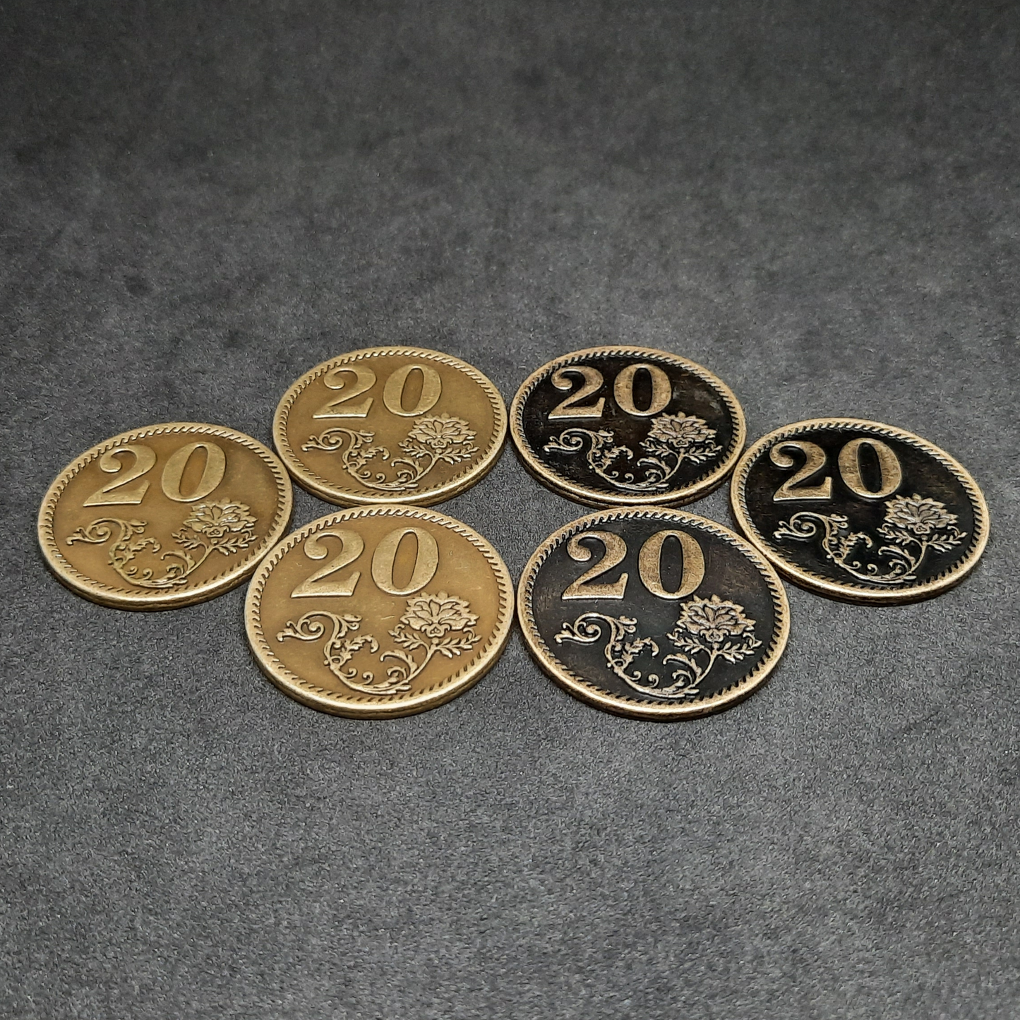 Set of bronze, silver and gold metal coins of value 1, 5 and 20 for board games