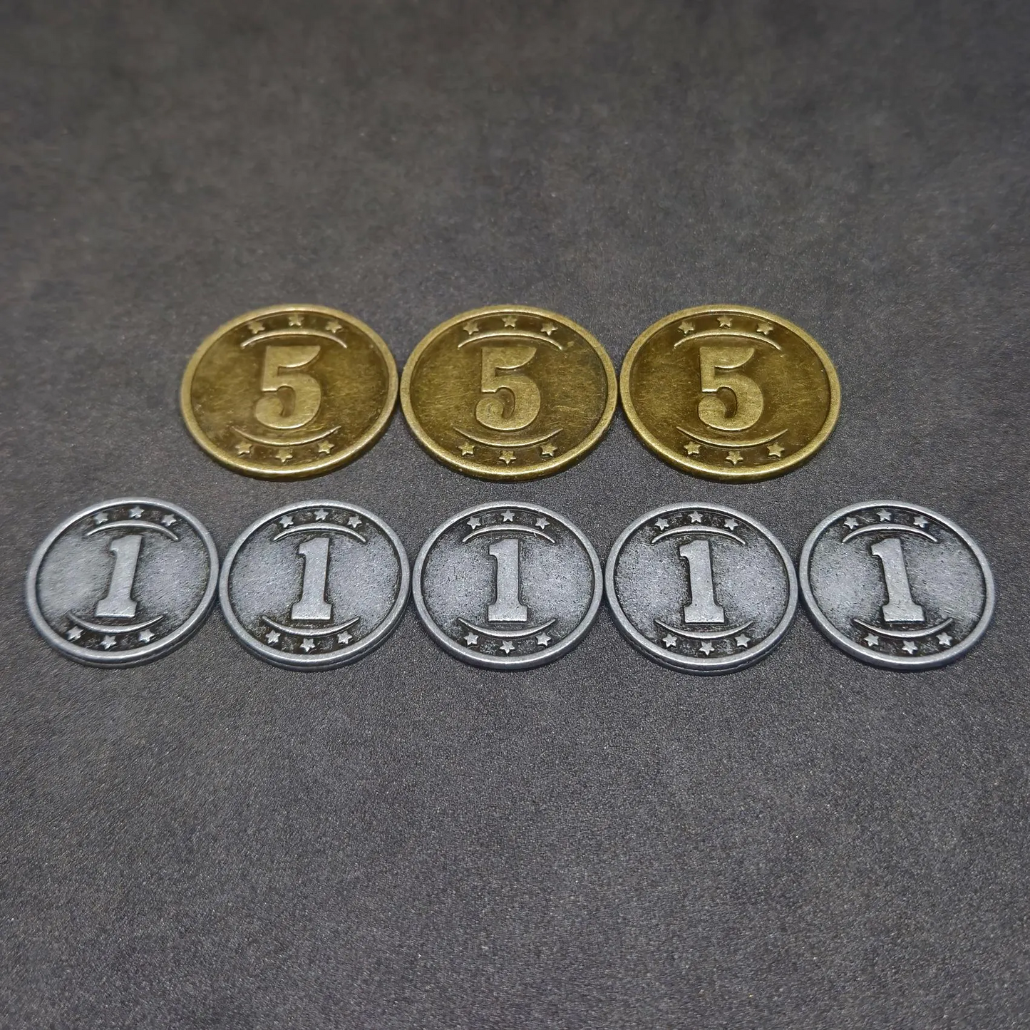 Set of silver and gold western metal coins of value 1 and 5 for board games