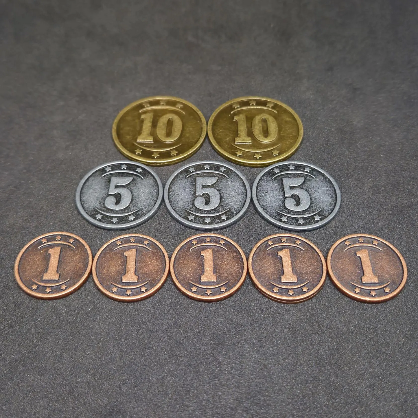 Set of bronze, silver and gold western metal coins of value 1, 5 and 10 for board games
