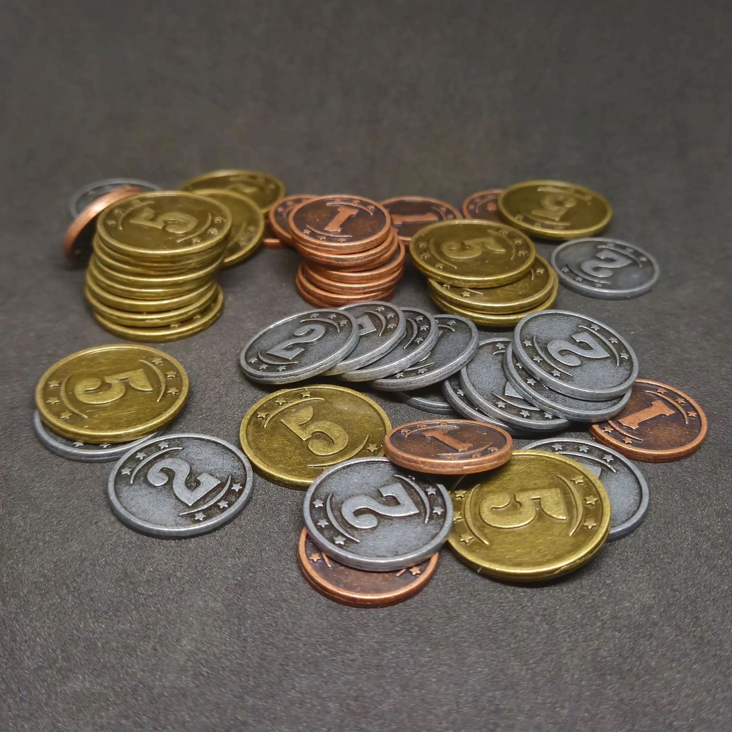 Set of bronze, silver and gold western metal coins of value 1, 2, and 5 for board games