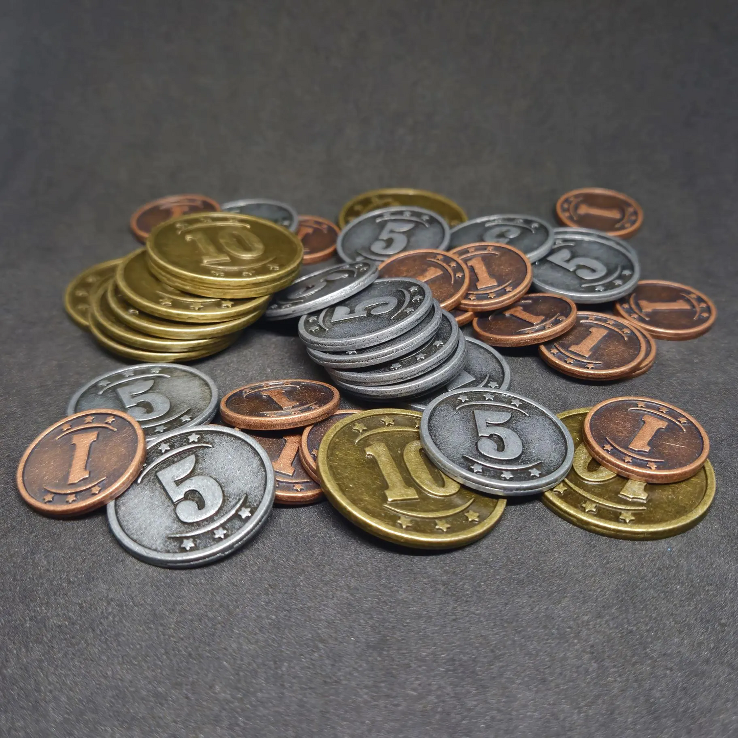 Set of bronze, silver and gold western metal coins of value 1, 5 and 10 for board games