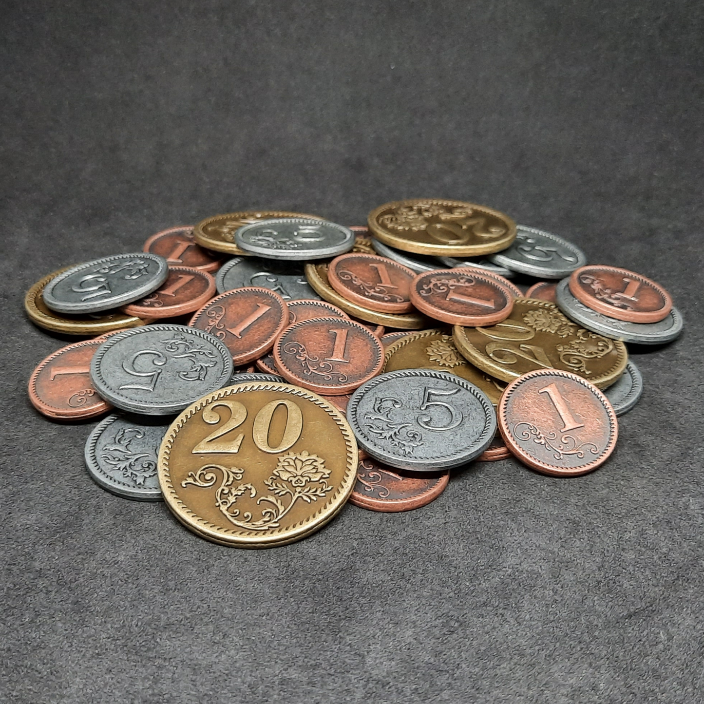 Set of bronze, silver and gold metal coins of value 1, 5 and 20 for board games