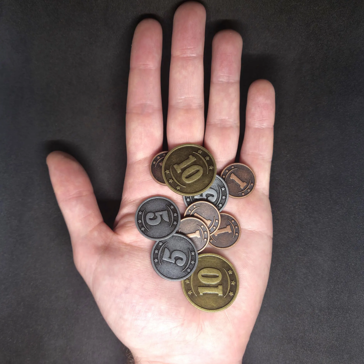 Set of bronze, silver and gold western metal coins of value 1, 5 and 10 for board games