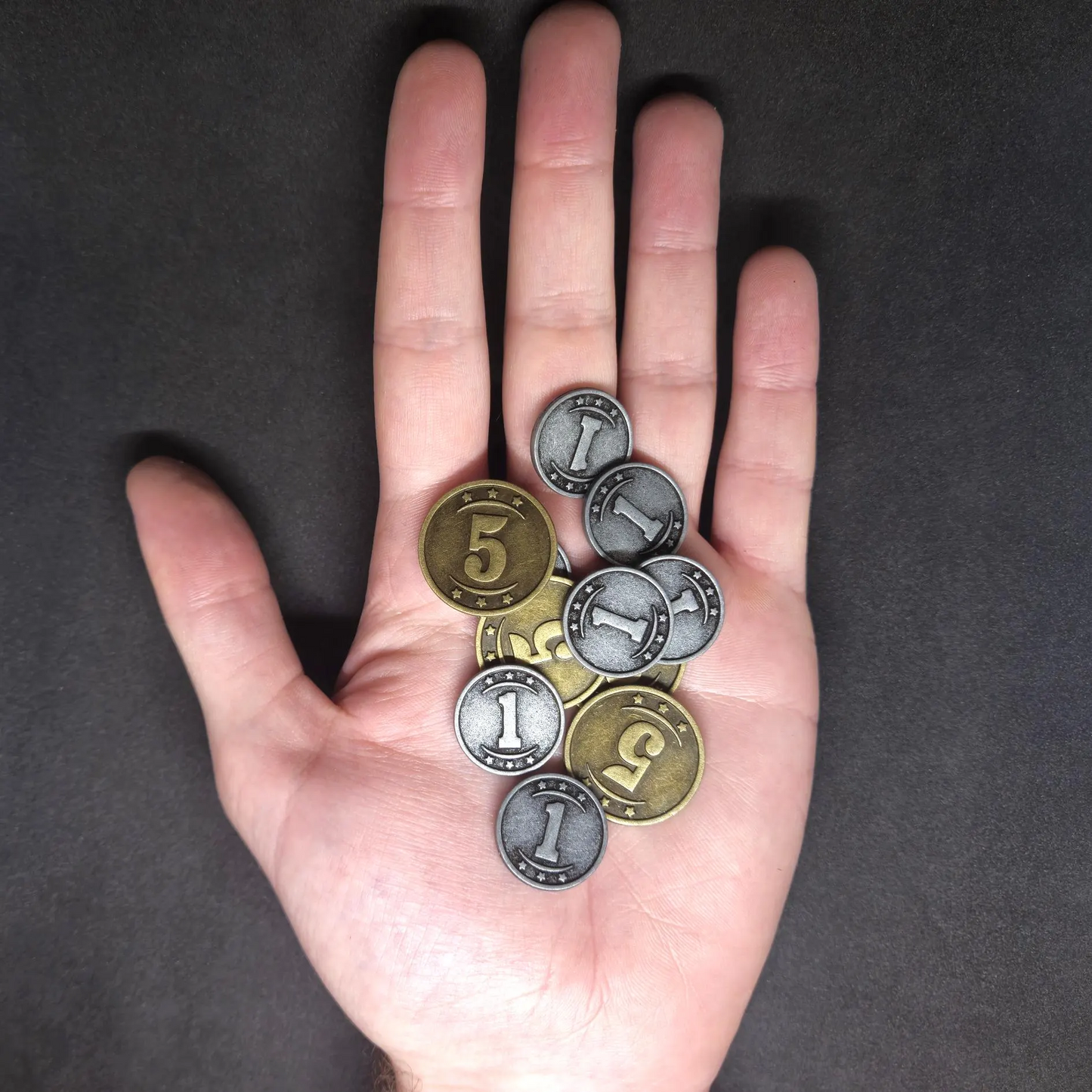 Set of silver and gold western metal coins of value 1 and 5 for board games