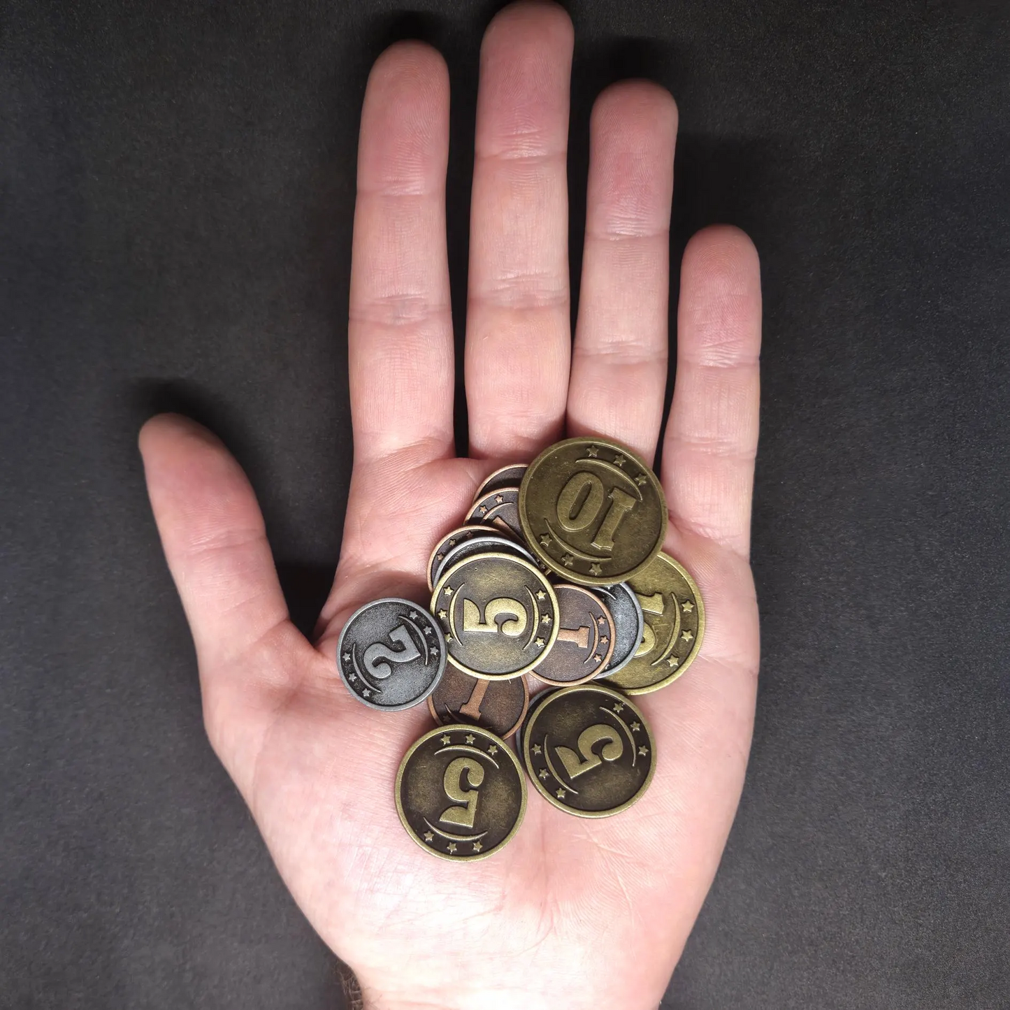 Set of bronze, silver and gold western metal coins of value 1, 2, 5 and 10 for board games