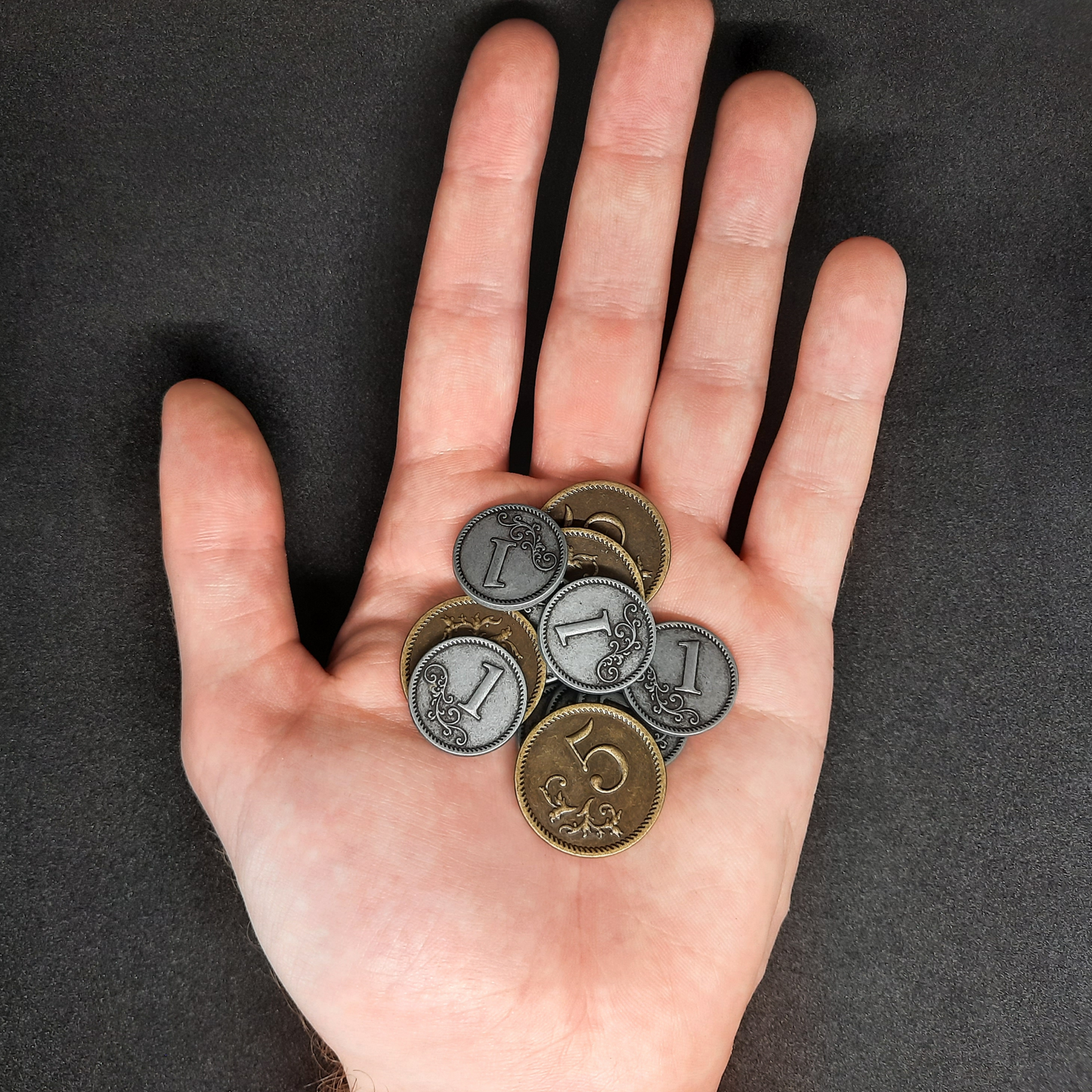 Set of silver and gold metal coins of value 1 and 5 for board games