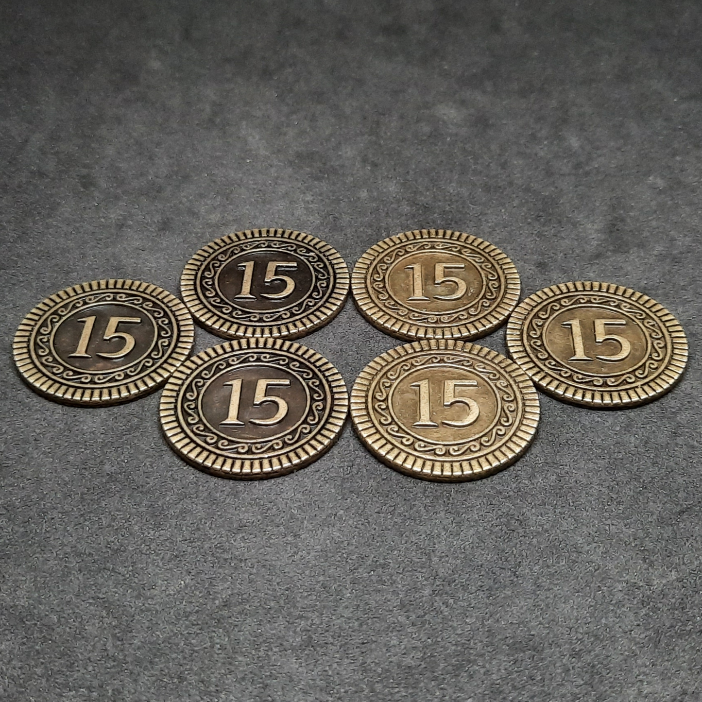 Set of bronze, silver and gold metal coins of value 1, 5 and 15 for board games