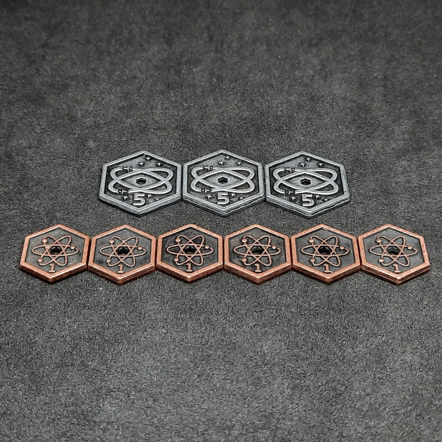 Set of spatial metal coins of value 1 and 5 for board games, hexagonal shape