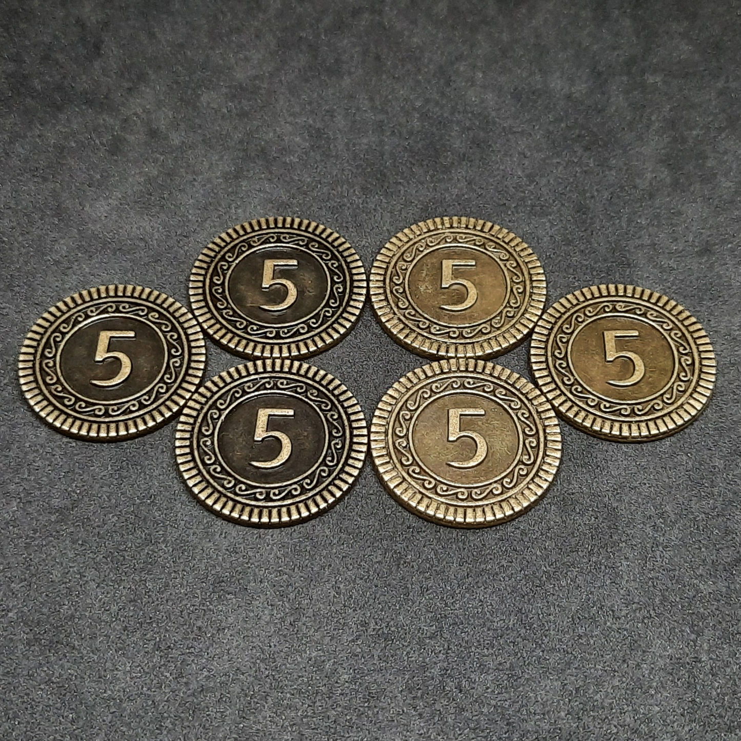 Set of bronze, silver and gold metal coins of value 1, 2 and 5 for board games