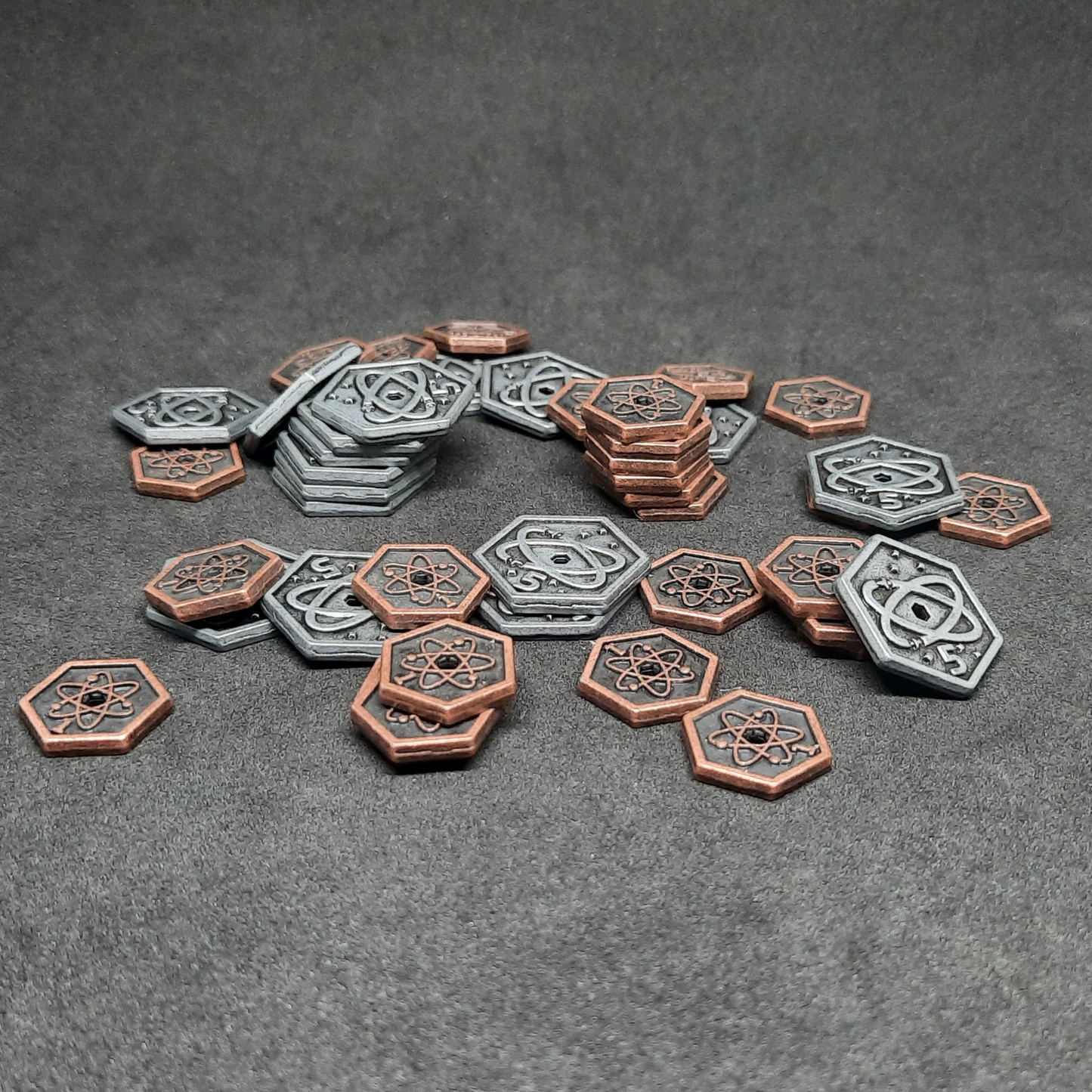 Set of spatial metal coins of value 1 and 5 for board games, hexagonal shape