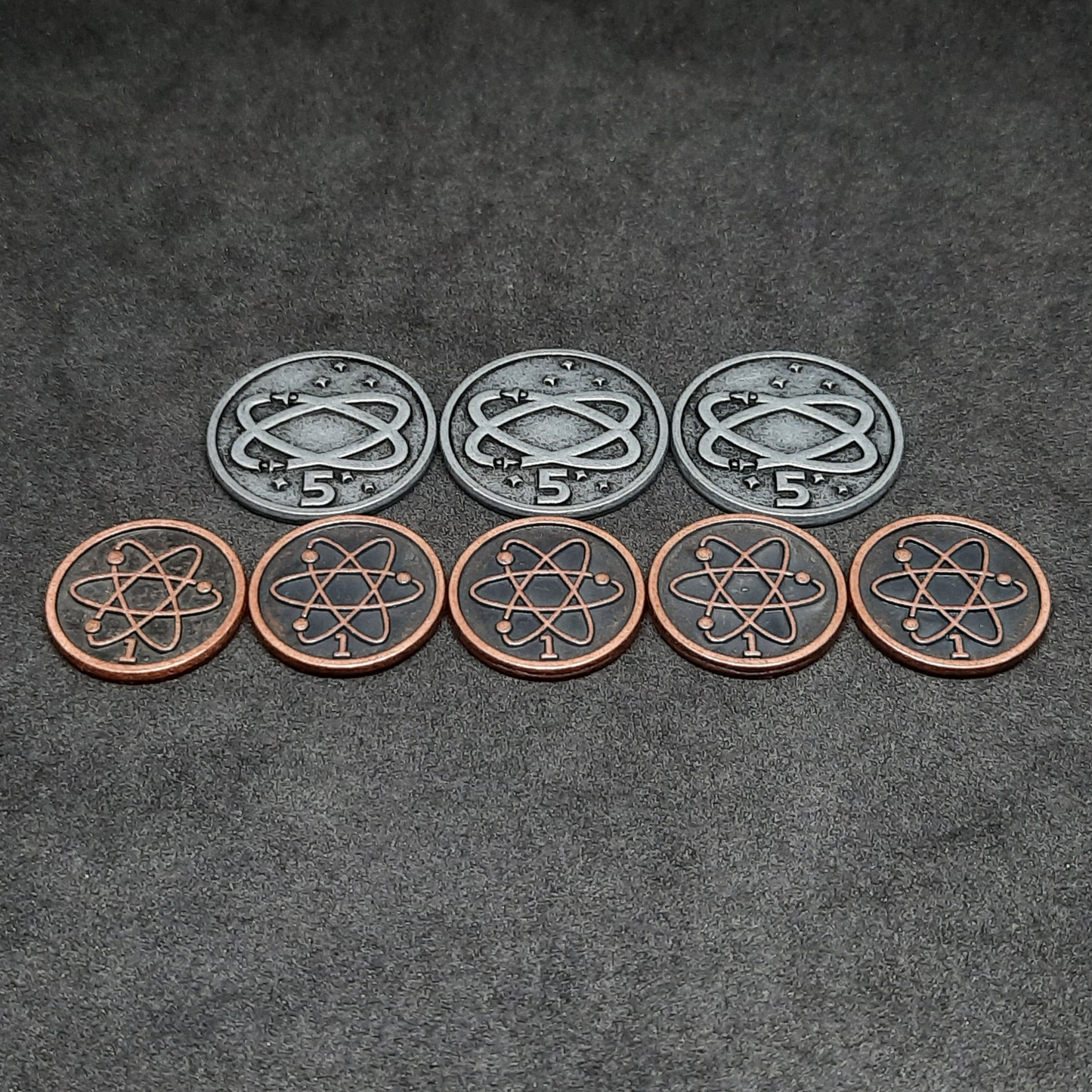 Set of spatial metal coins of value 1 and 5 for board games