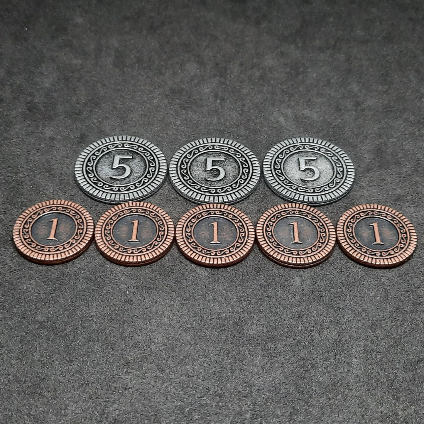 Set of bronze and silver metal coins of value 1 and 5 for board games