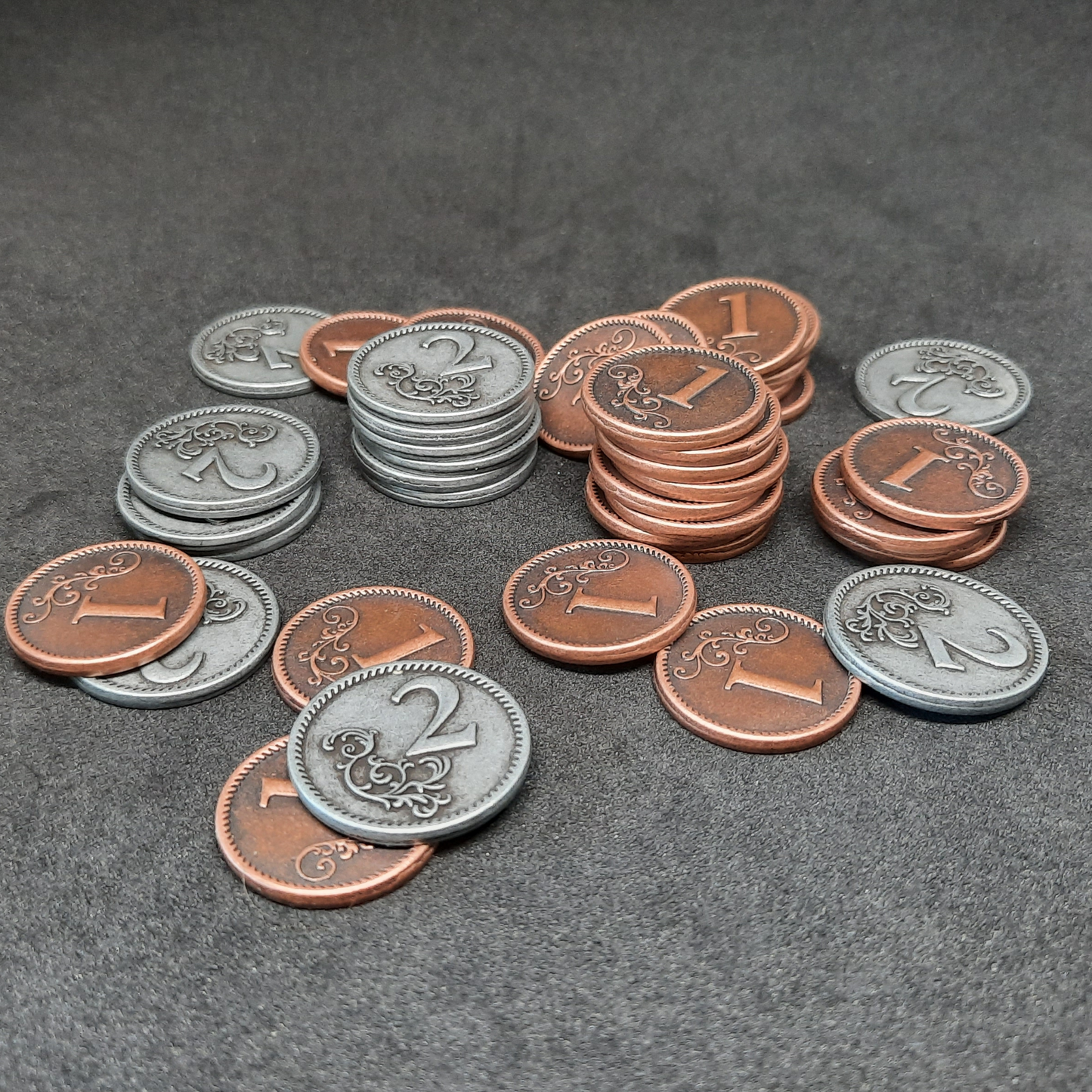 Set of bronze and silver metal coins of value 1 and 2 for board games