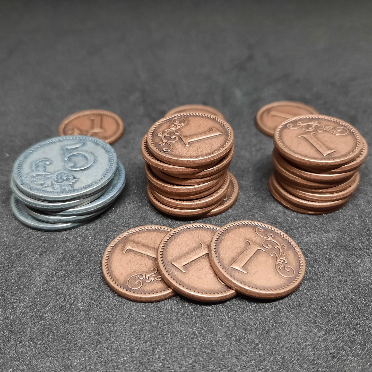 Set of bronze and silver metal coins of value 1 and 5 for board games