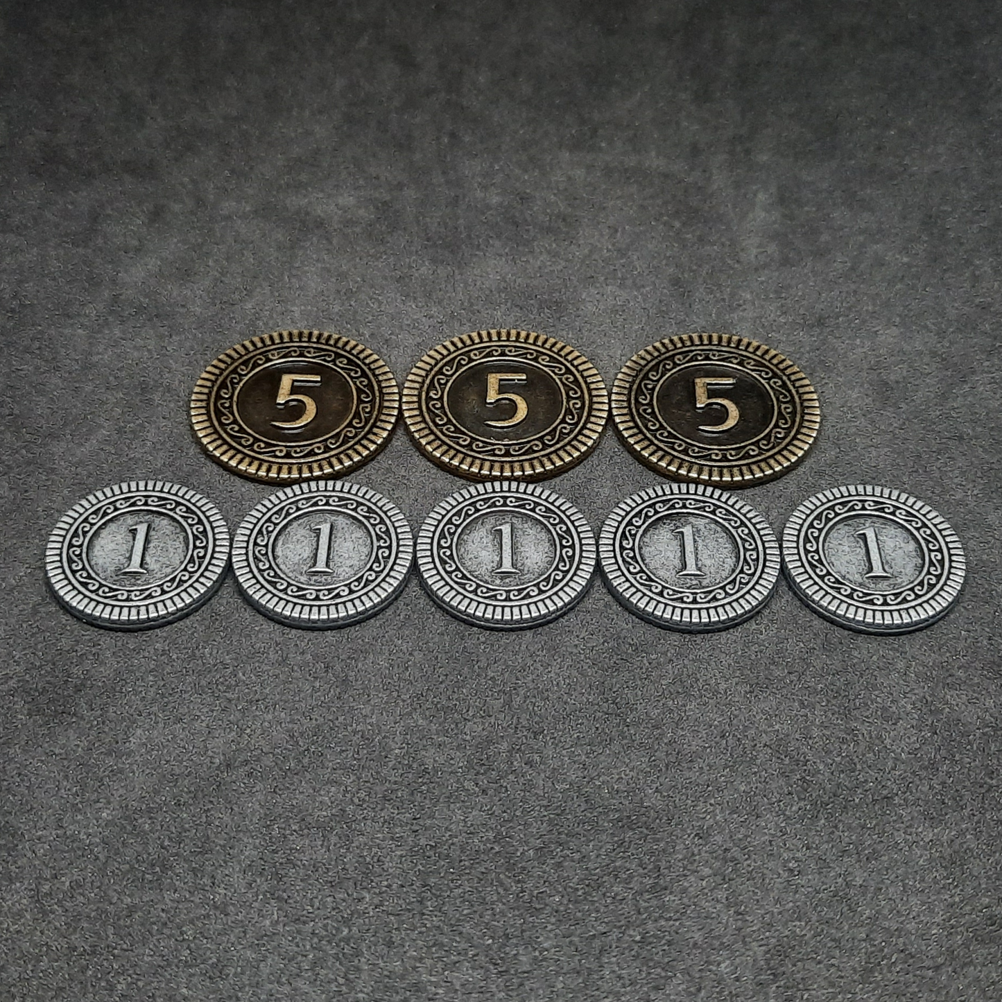 Set of silver and gold metal coins of value 1 and 5 for board games