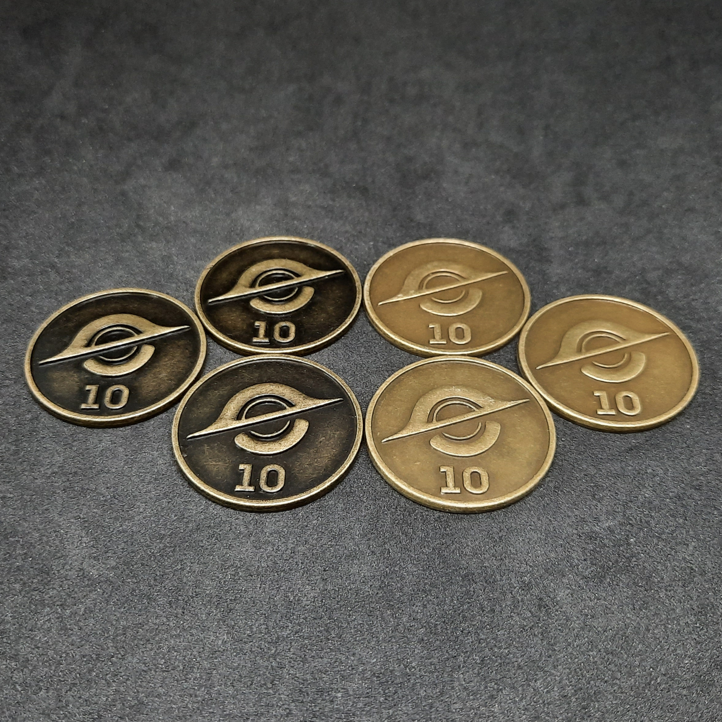 Set of bronze, silver and gold spatial metal coins of value 1, 5 and 10 for board games