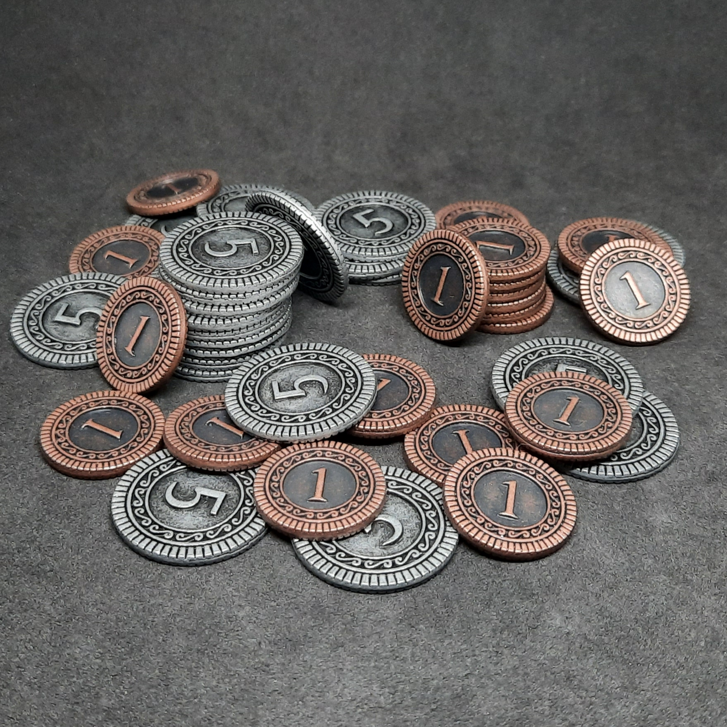 Set of bronze and silver metal coins of value 1 and 5 for board games