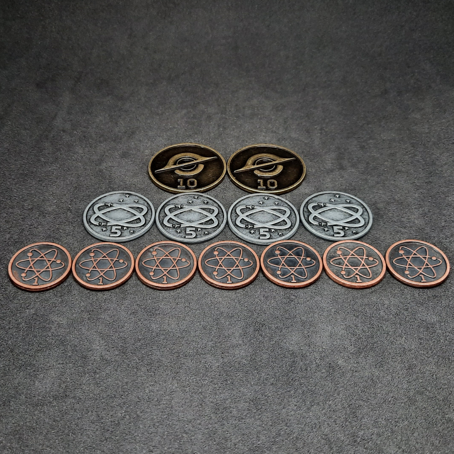 Set of bronze, silver and gold spatial metal coins of value 1, 5 and 10 for board games