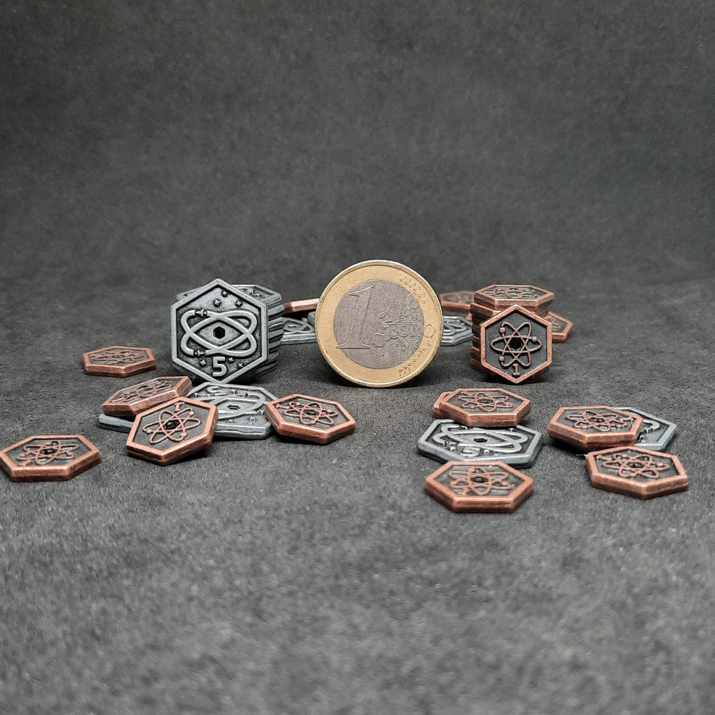 Set of spatial metal coins of value 1 and 5 for board games, hexagonal shape