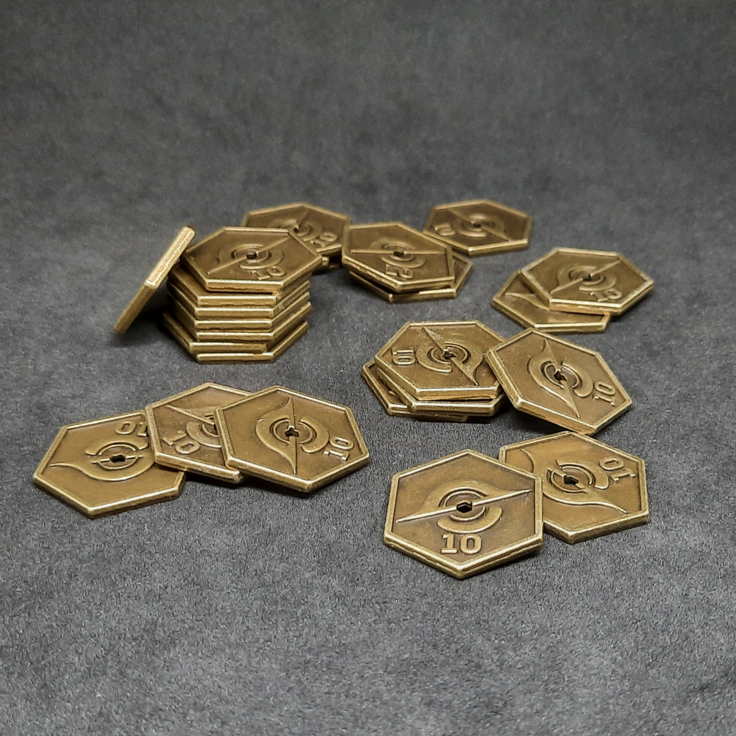 Gold spatial metal coins of value 10 for board games, hexagonal shape