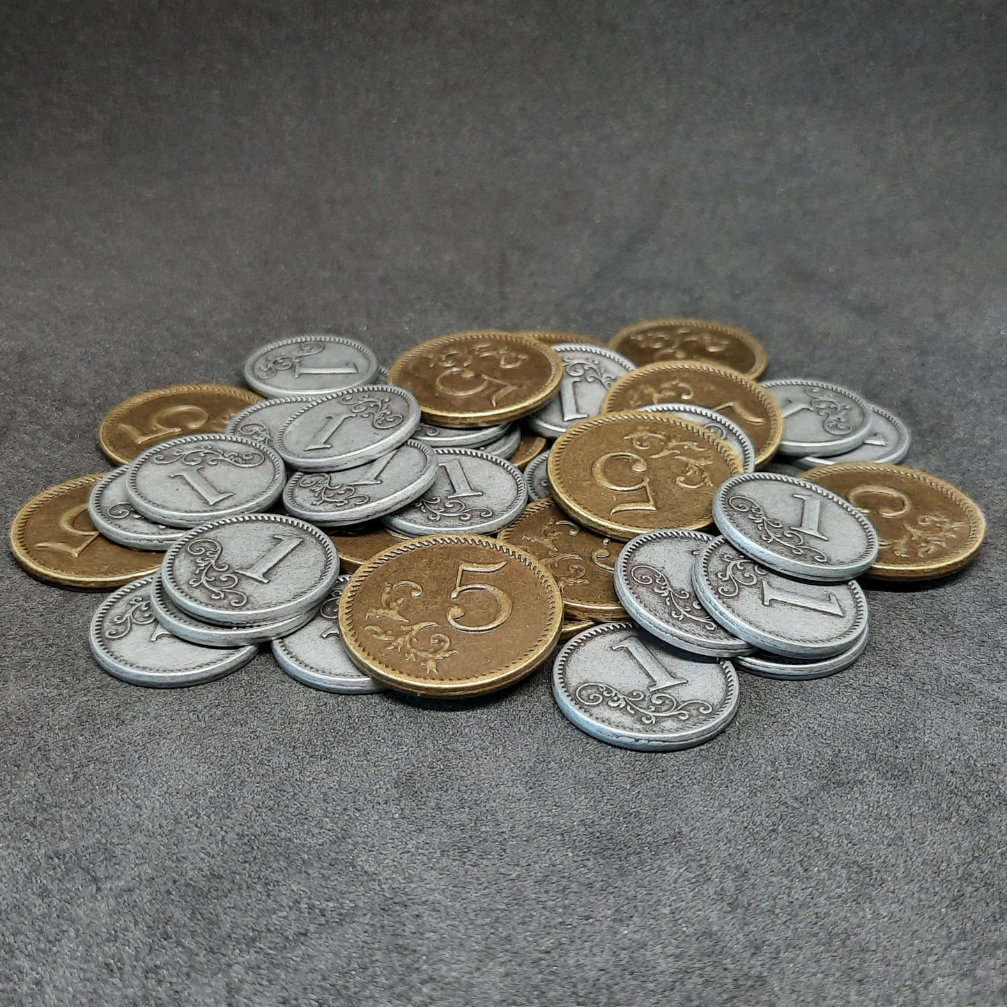 Set of silver and gold metal coins of value 1 and 5 for board games