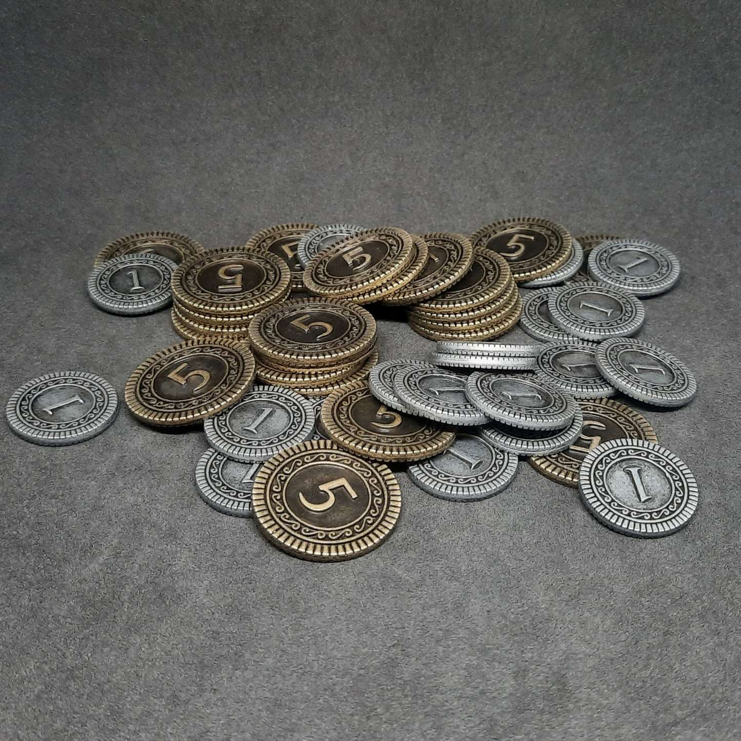 Set of silver and gold metal coins of value 1 and 5 for board games