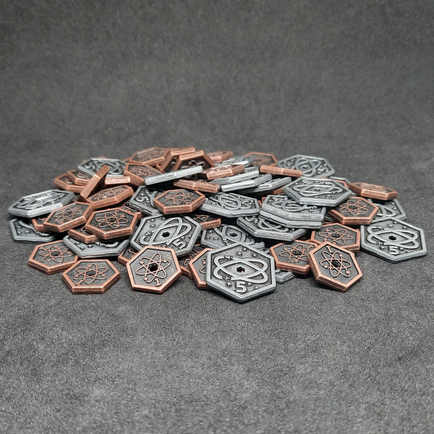 Set of spatial metal coins of value 1 and 5 for board games, hexagonal shape