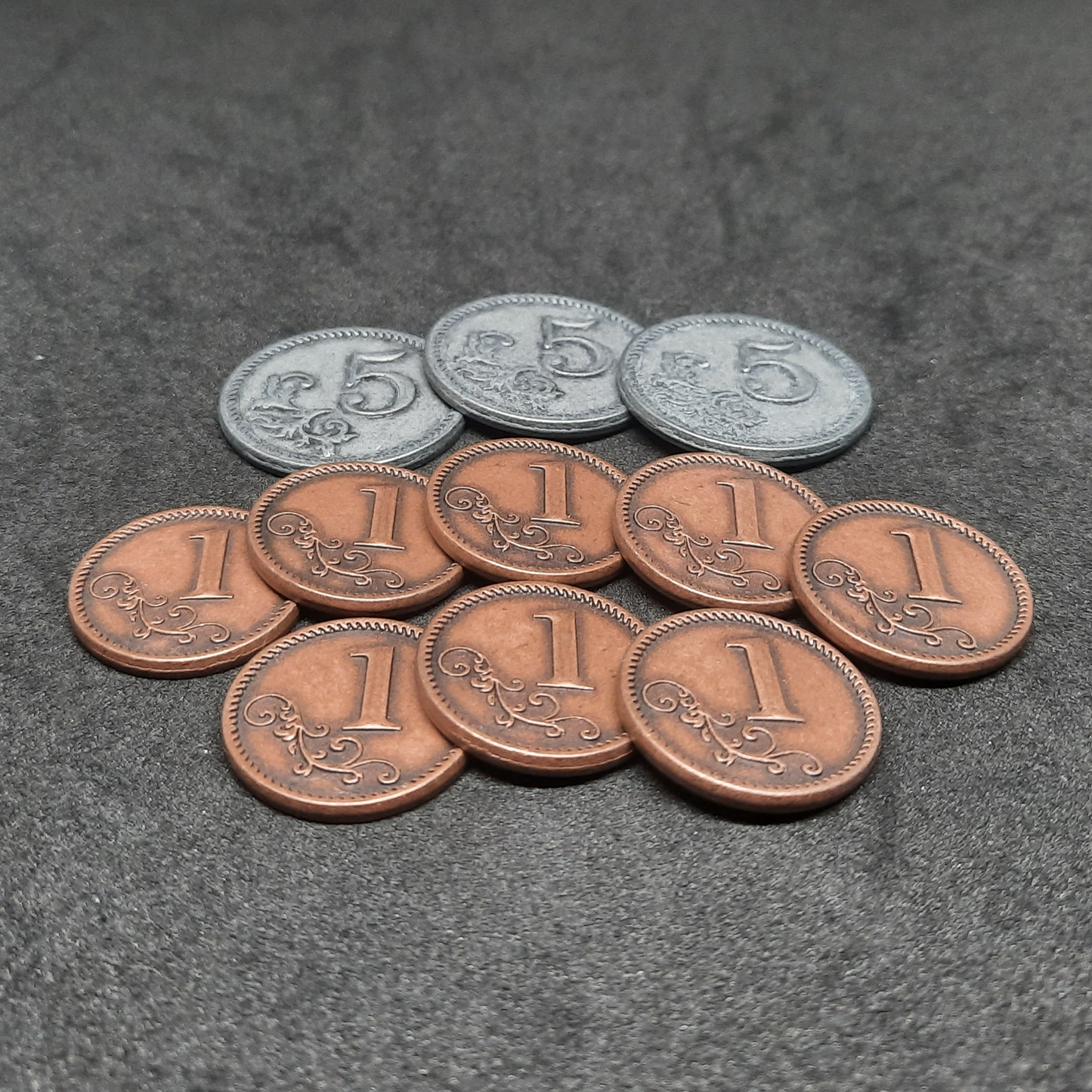 Set of bronze and silver metal coins of value 1 and 5 for board games