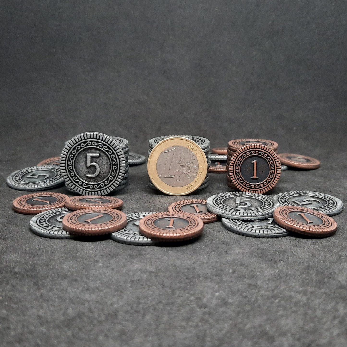 Set of bronze and silver metal coins of value 1 and 5 for board games