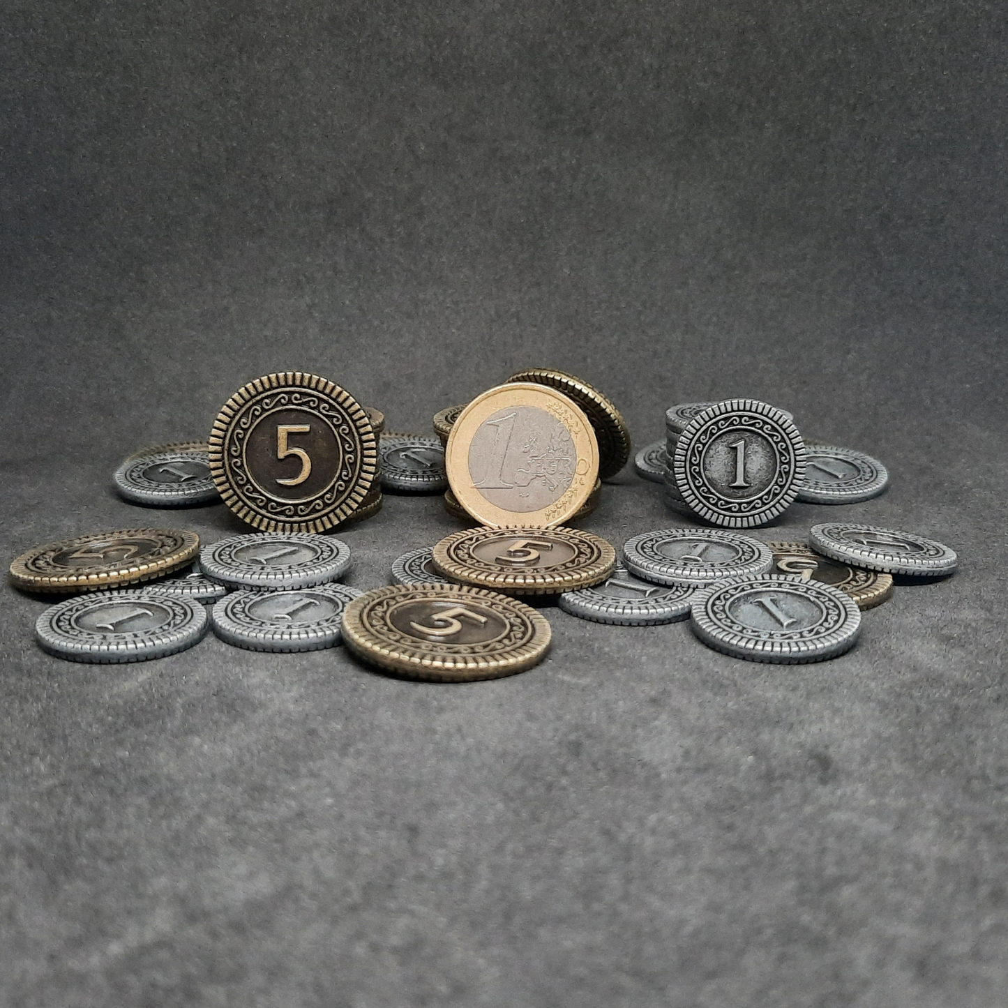 Set of silver and gold metal coins of value 1 and 5 for board games