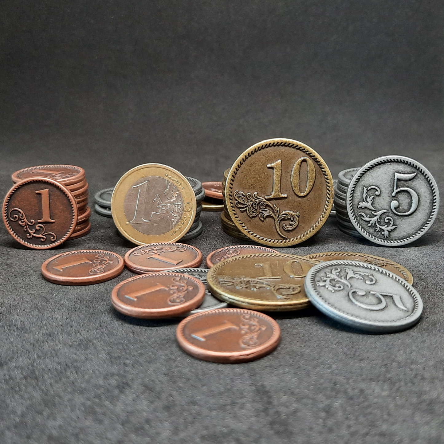 Set of bronze, silver and gold metal coins of value 1, 5 and 10 for board games