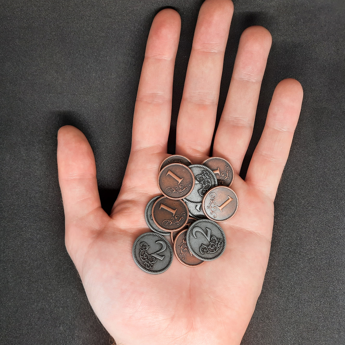 Set of bronze and silver metal coins of value 1 and 2 for board games