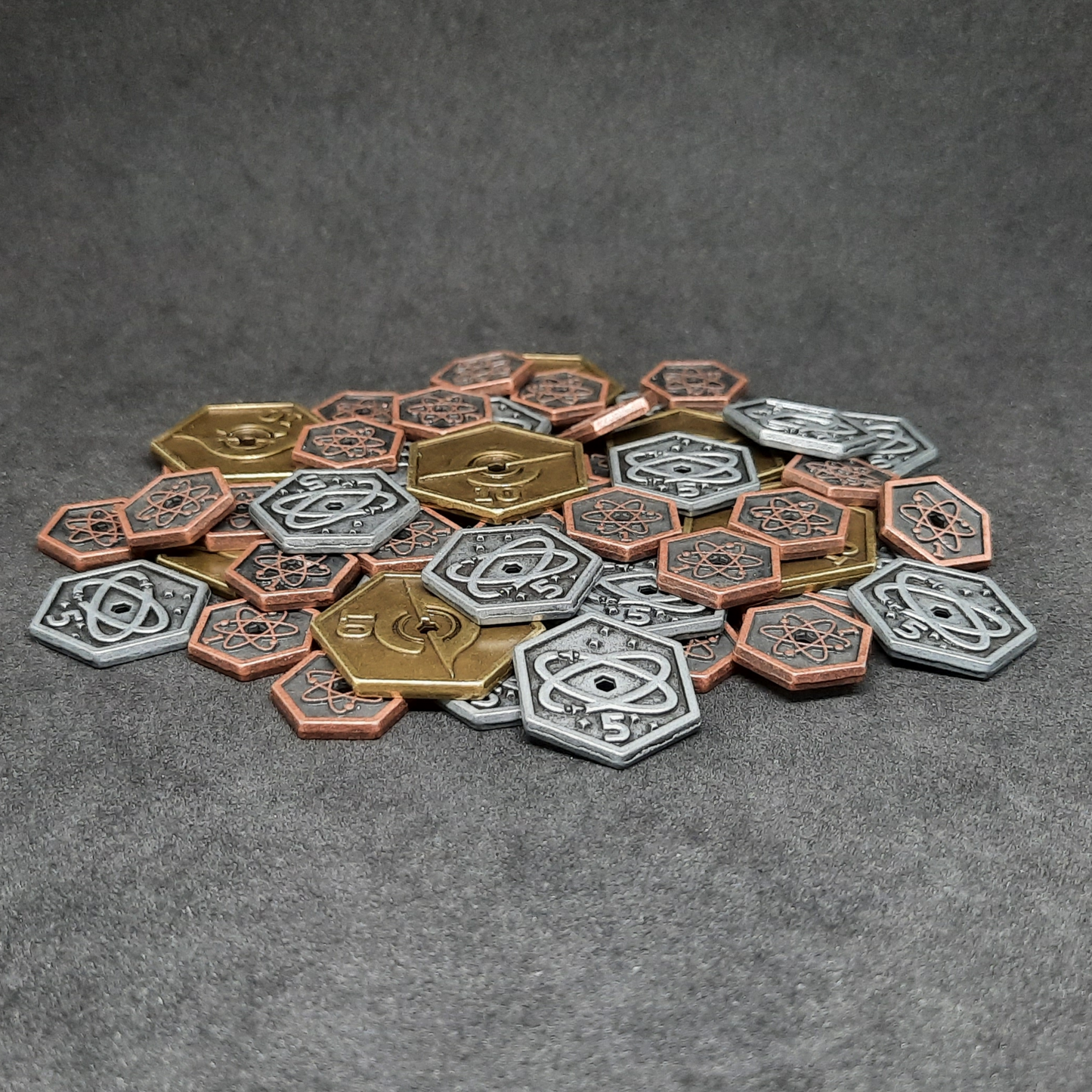 Set of spatial metal coins of value 1, 5 and 10 for board games, hexagonal shape