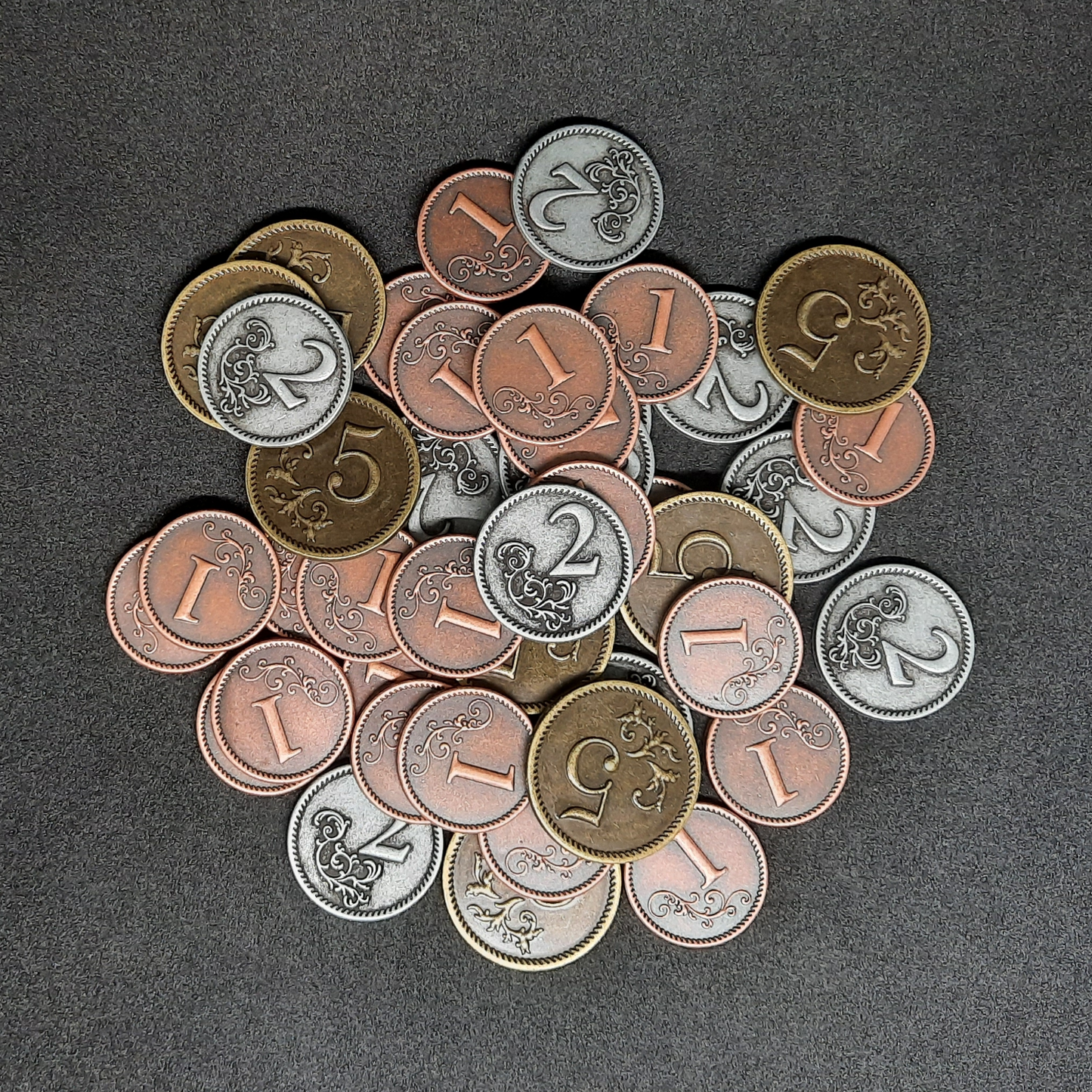 Set of bronze, silver and gold metal coins of value 1, 2 and 5 for board games