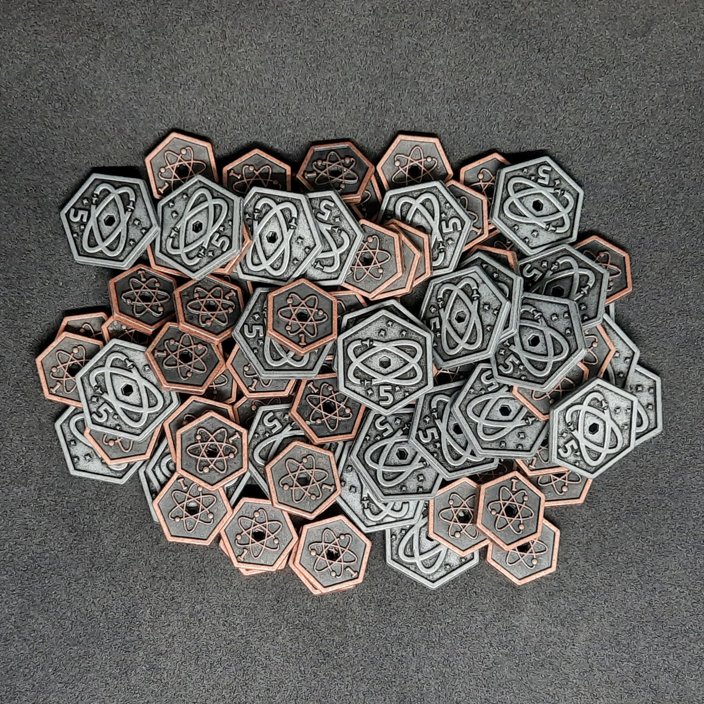 Set of spatial metal coins of value 1 and 5 for board games, hexagonal shape