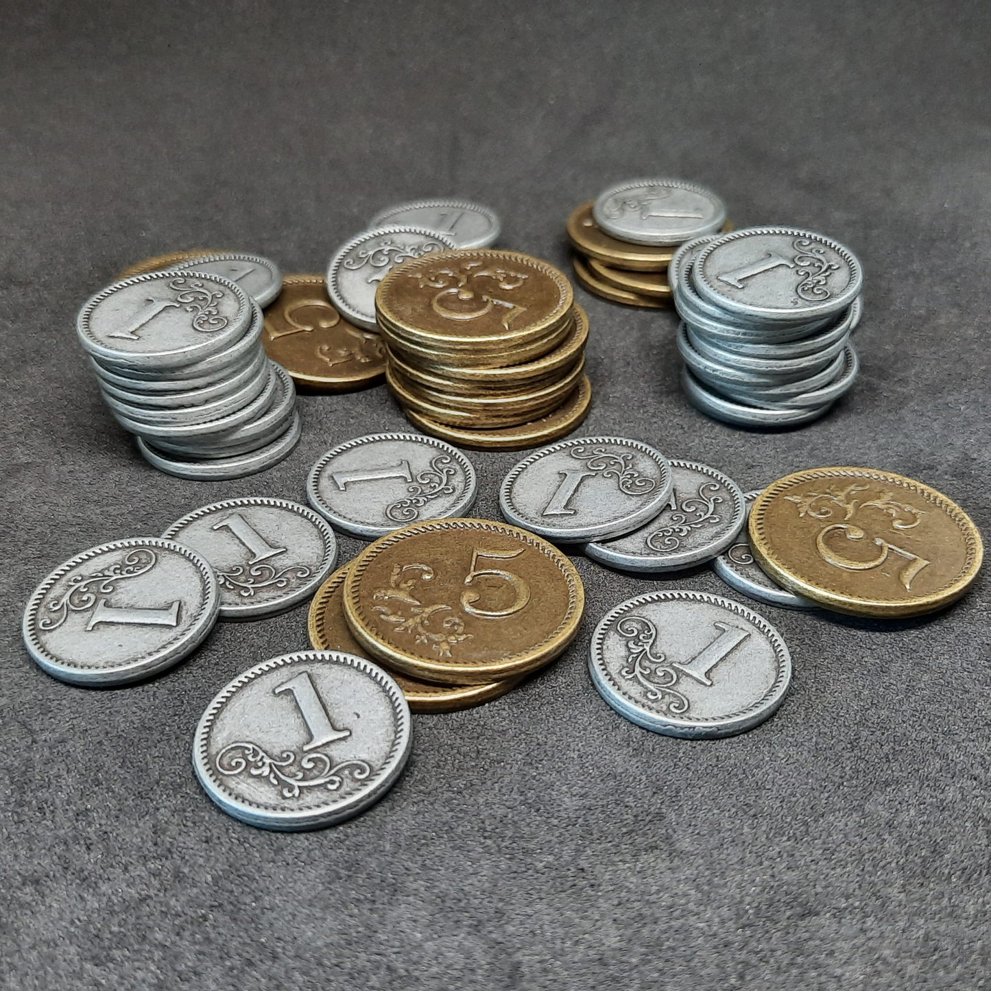 Set of silver and gold metal coins of value 1 and 5 for board games