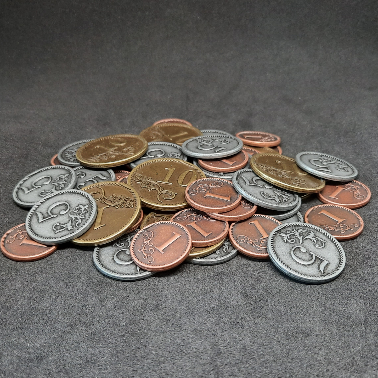 Set of bronze, silver and gold metal coins of value 1, 5 and 10 for board games