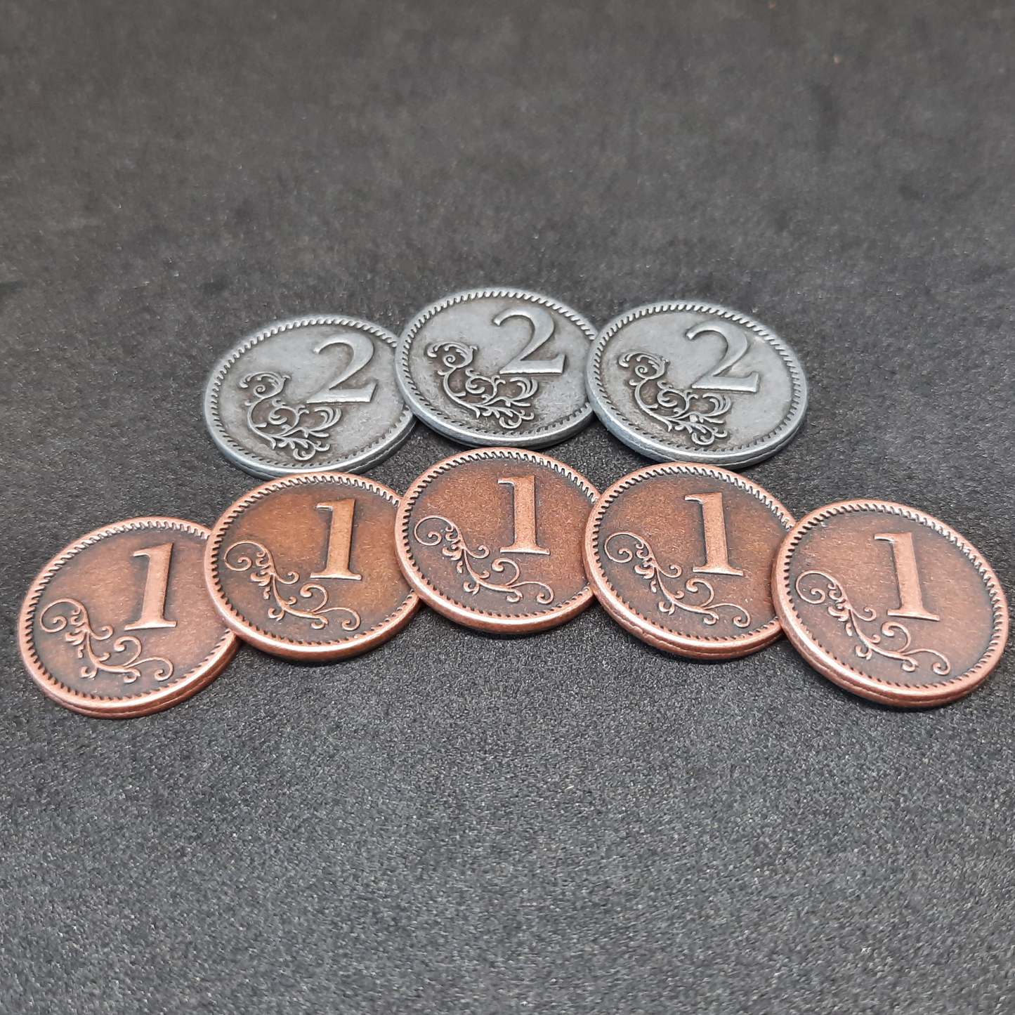 Set of bronze and silver metal coins of value 1 and 2 for board games